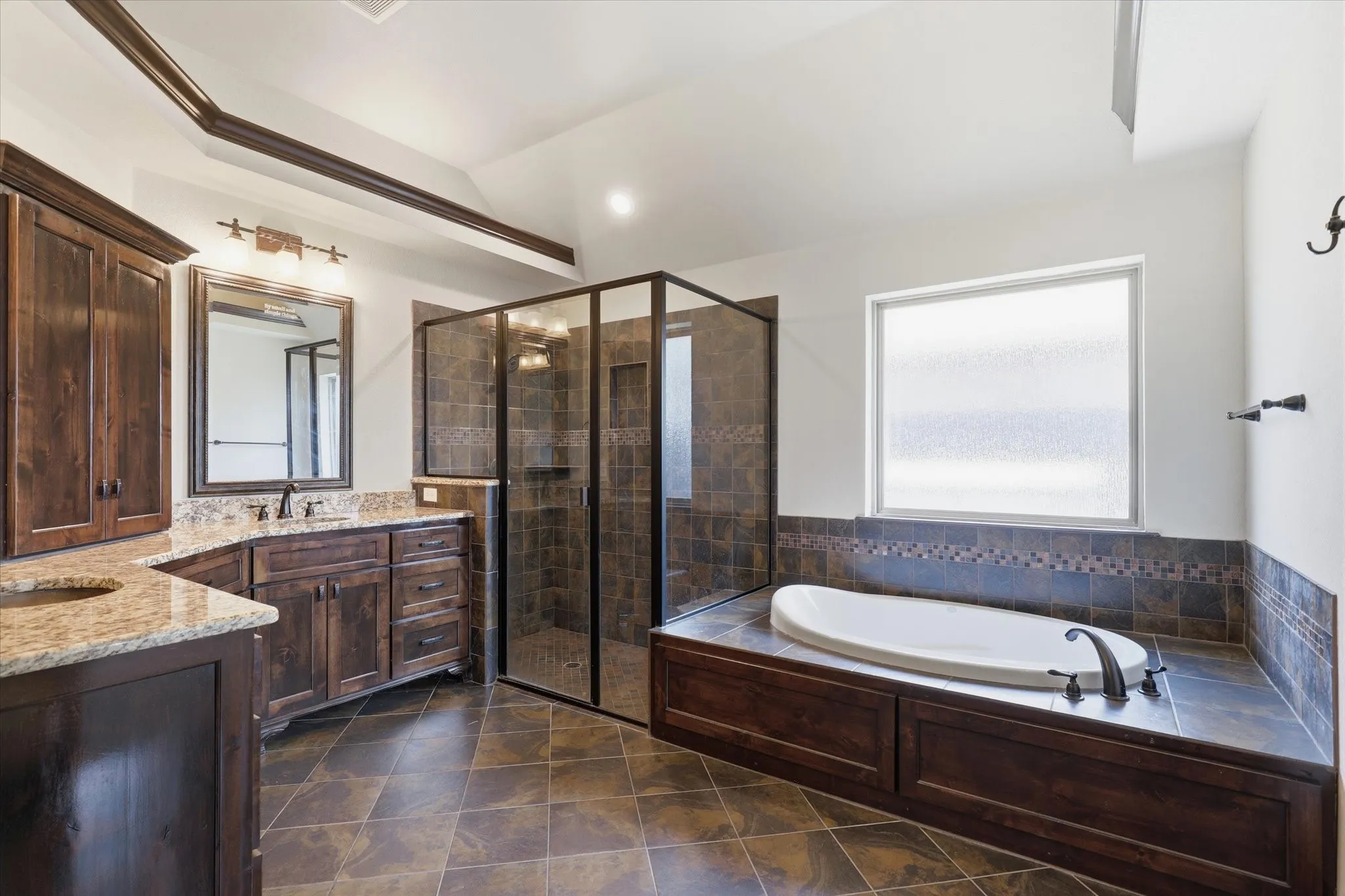 Tray ceiling accented with dark crown molding adds another custom architectural element.