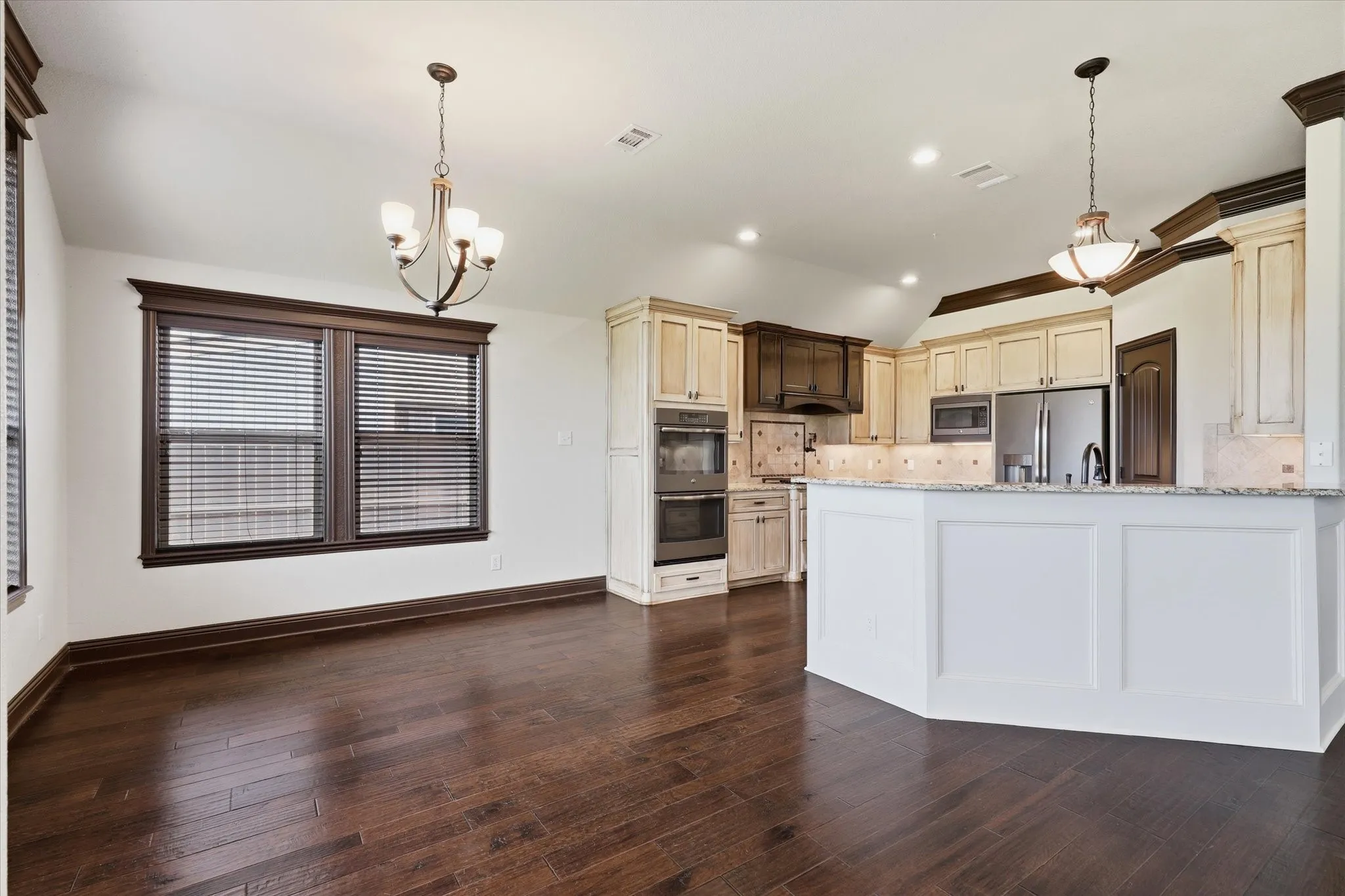 Open dining area with hardwood floors, custom millwork, abundant natural light.