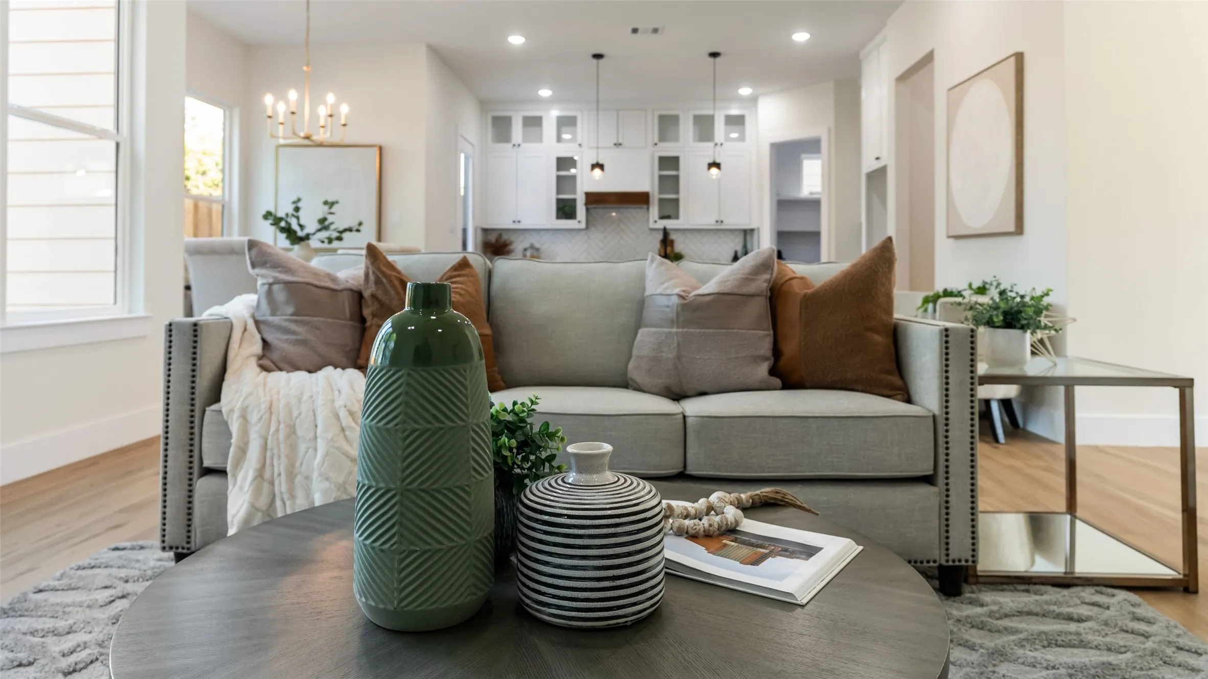 Bright living area featuring wood-finish flooring, recessed lighting, and a chandelier