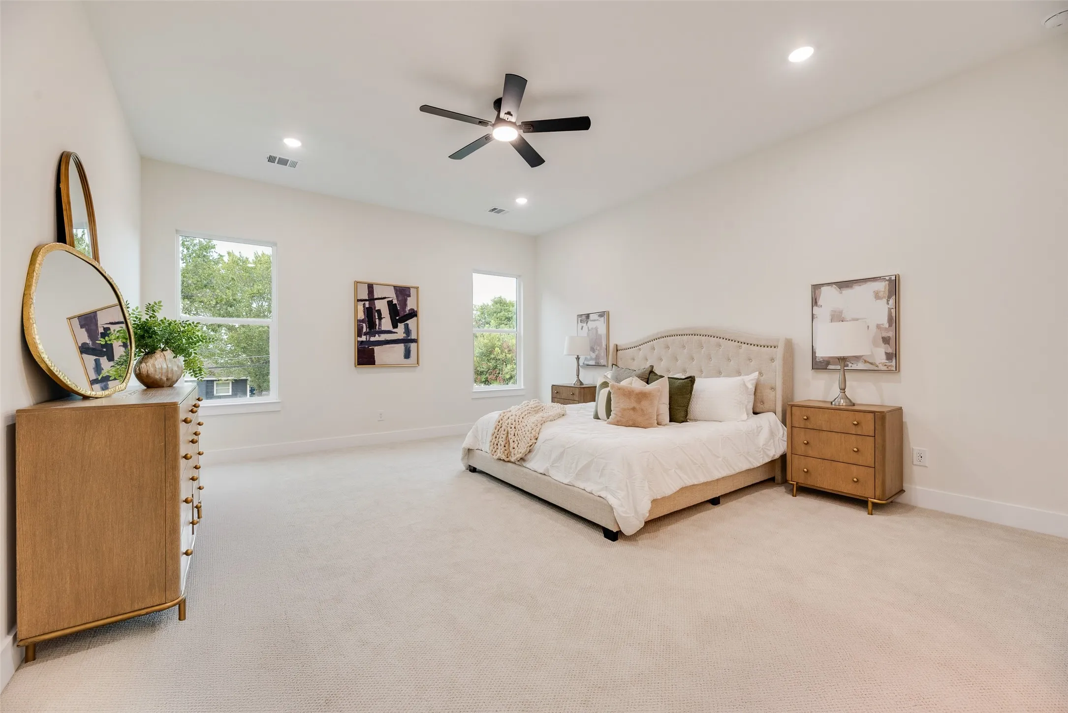 Vaulted ceiling with a ceiling fan, recessed lighting, double windows, and light-toned carpeting