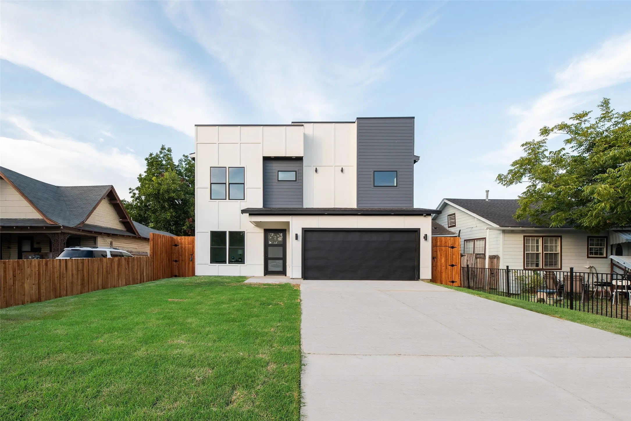 Contemporary exterior with a black garage door and an integrated front entry