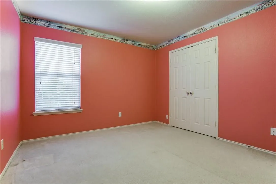 Unfurnished bedroom with carpet flooring and a closet