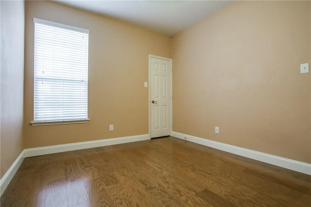 Empty room featuring wood-type flooring