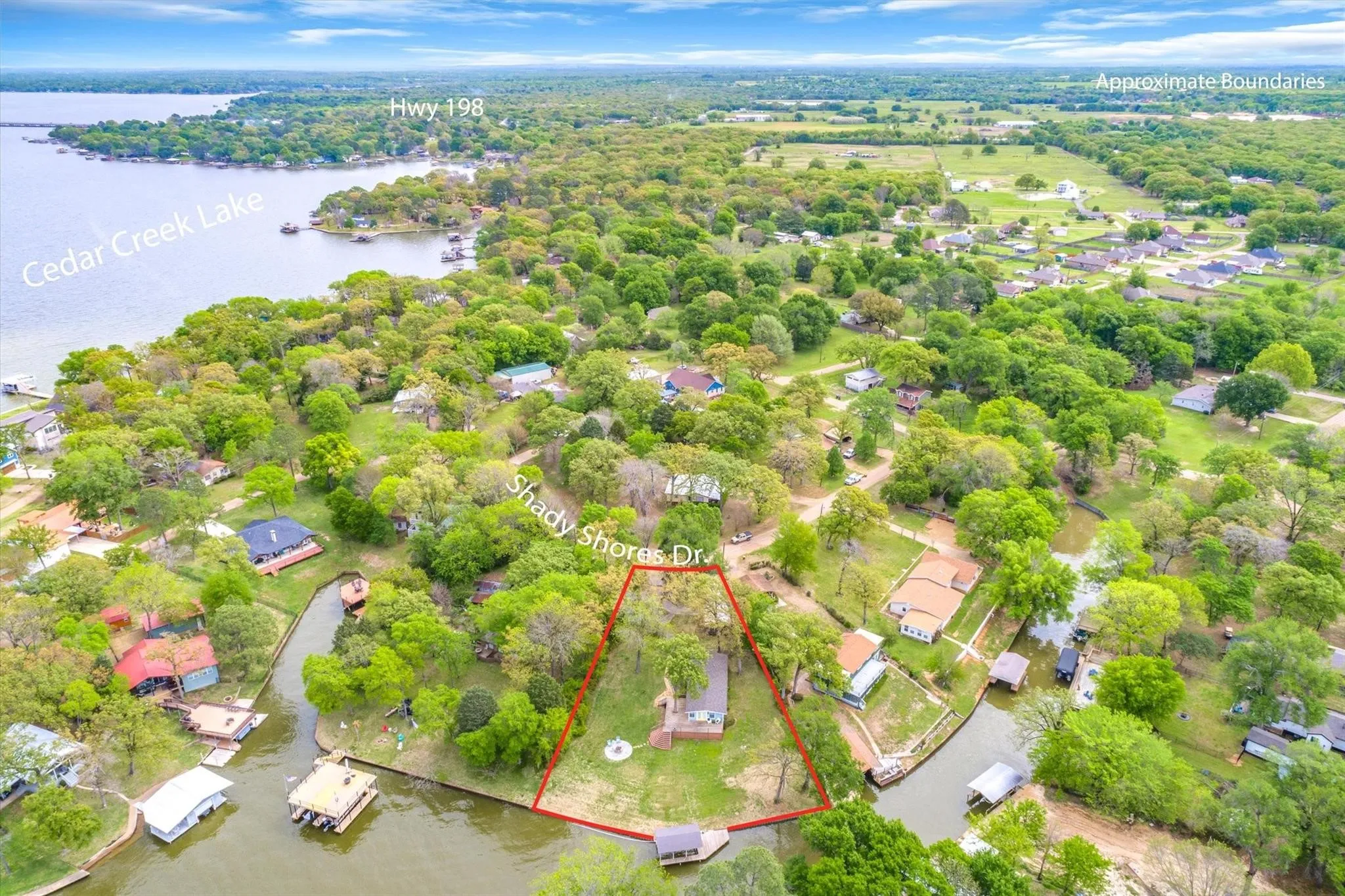 Aerial perspective showcasing property within a lush, tree-filled landscape
