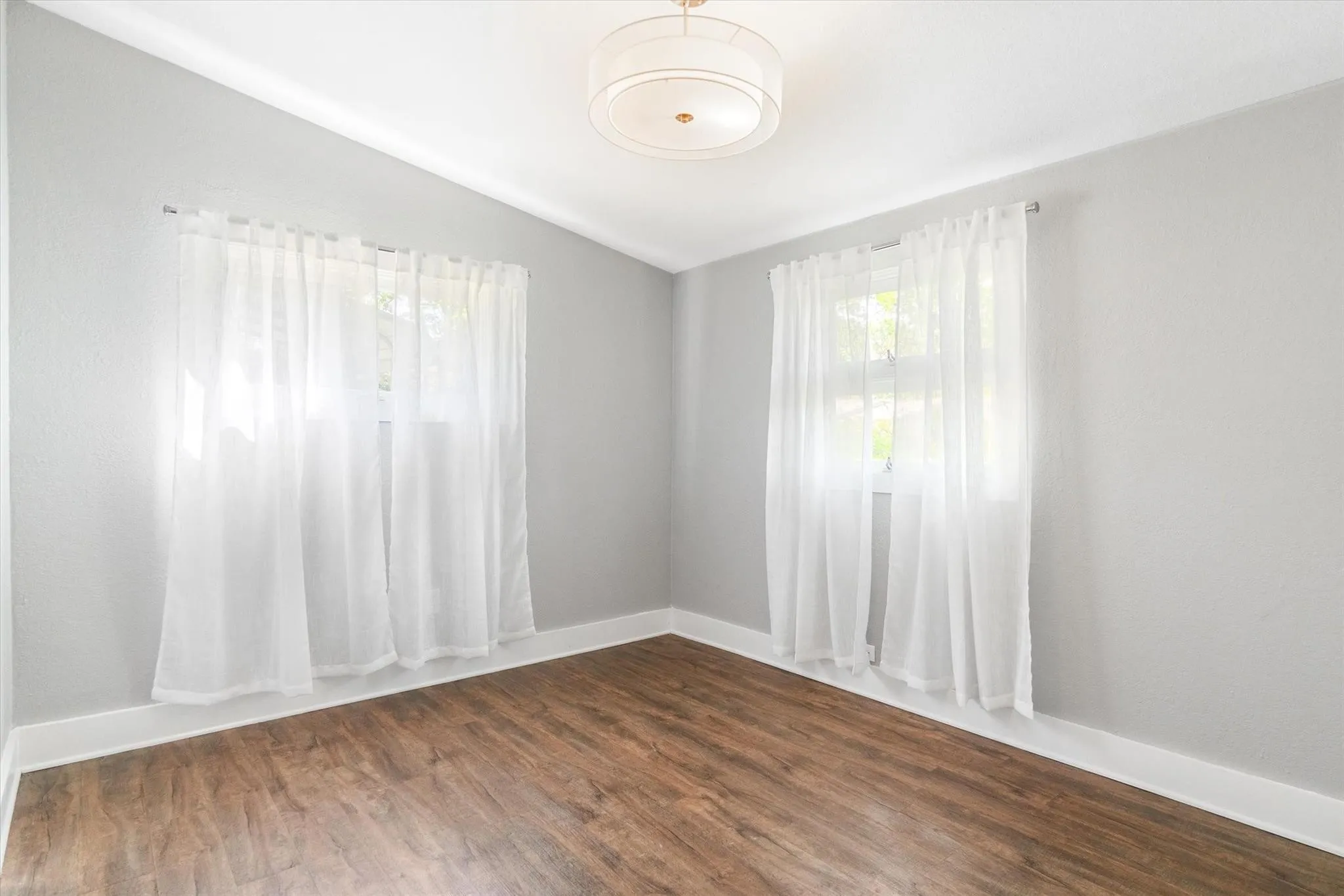 Neutral wall tones, wood-finish flooring, and white trim