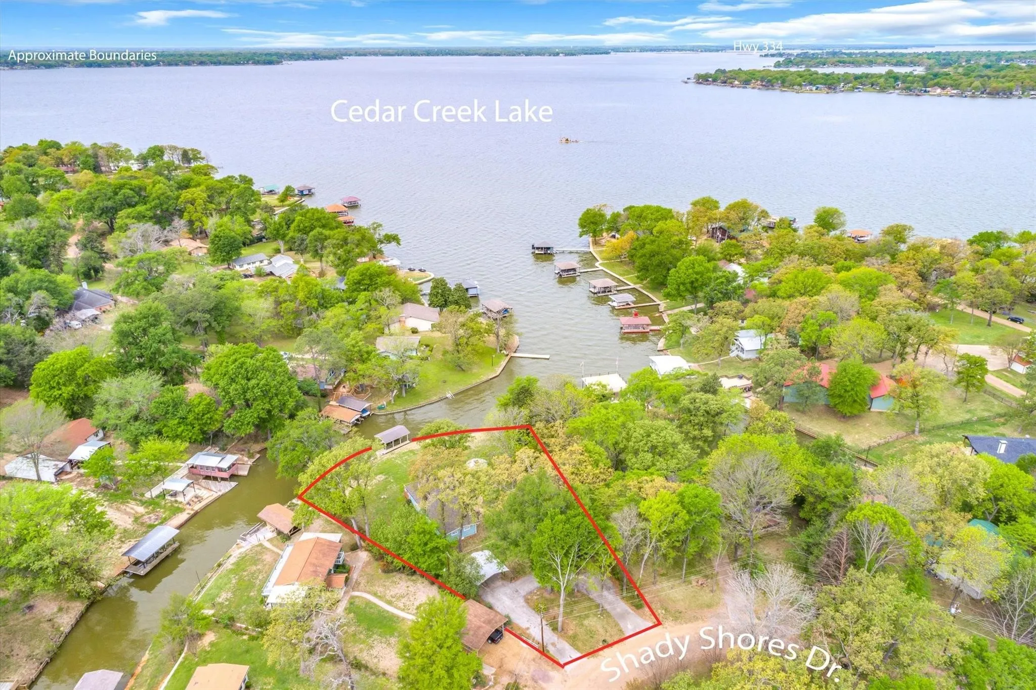 Waterfront property featuring Cedar Creek Lake access, mature trees, and a private boat dock