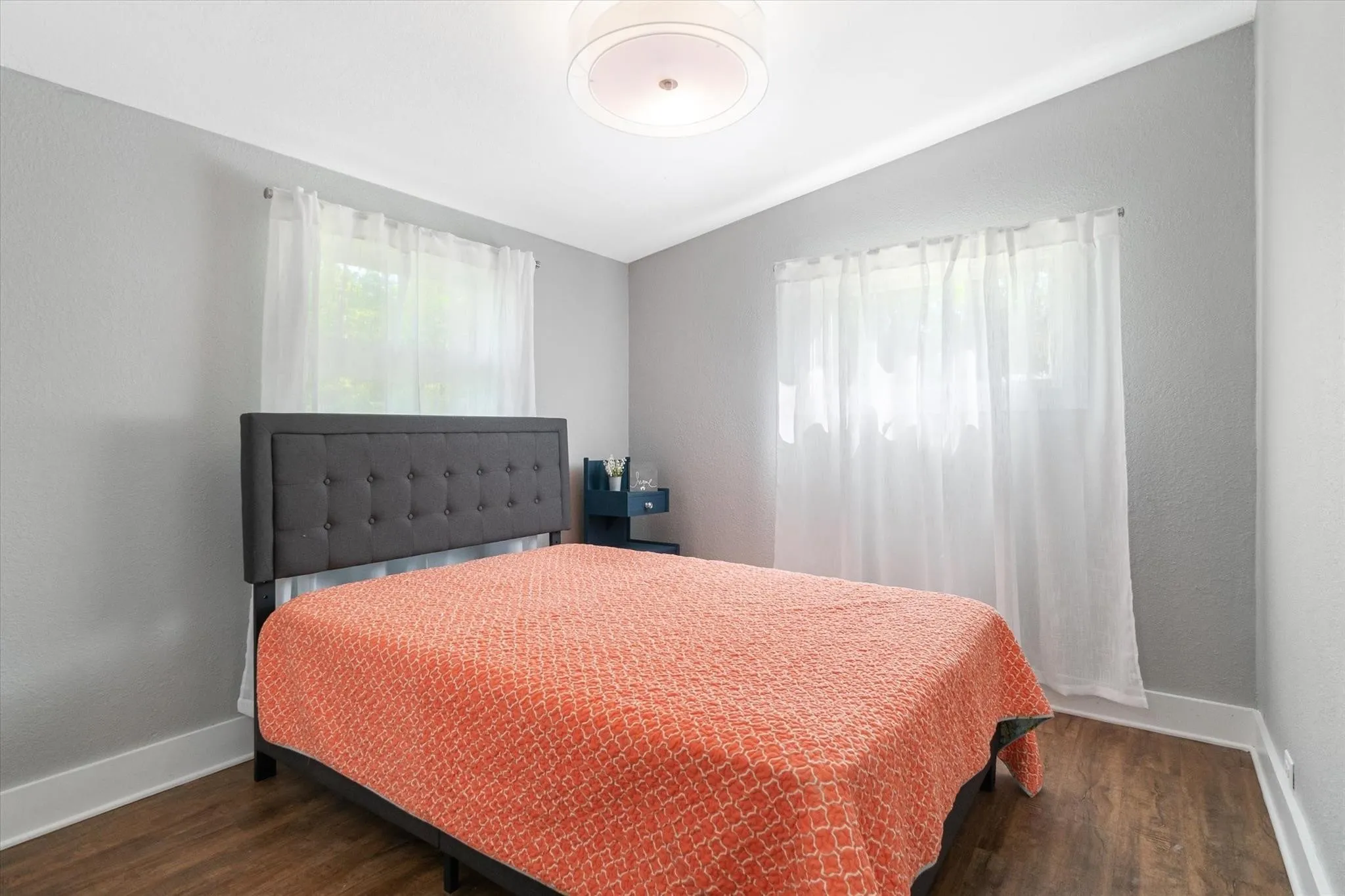 Recessed lighting, wood-finish flooring, white trim, and light gray wall finish