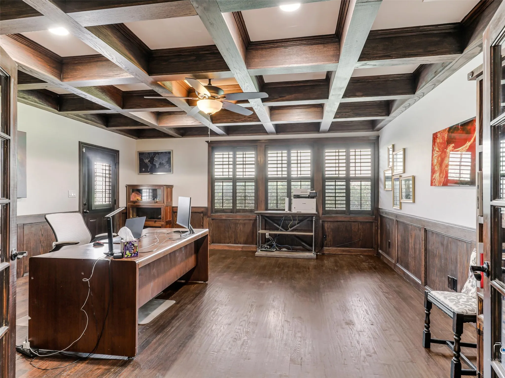 Coffered wood ceiling with recessed lighting and a ceiling fan