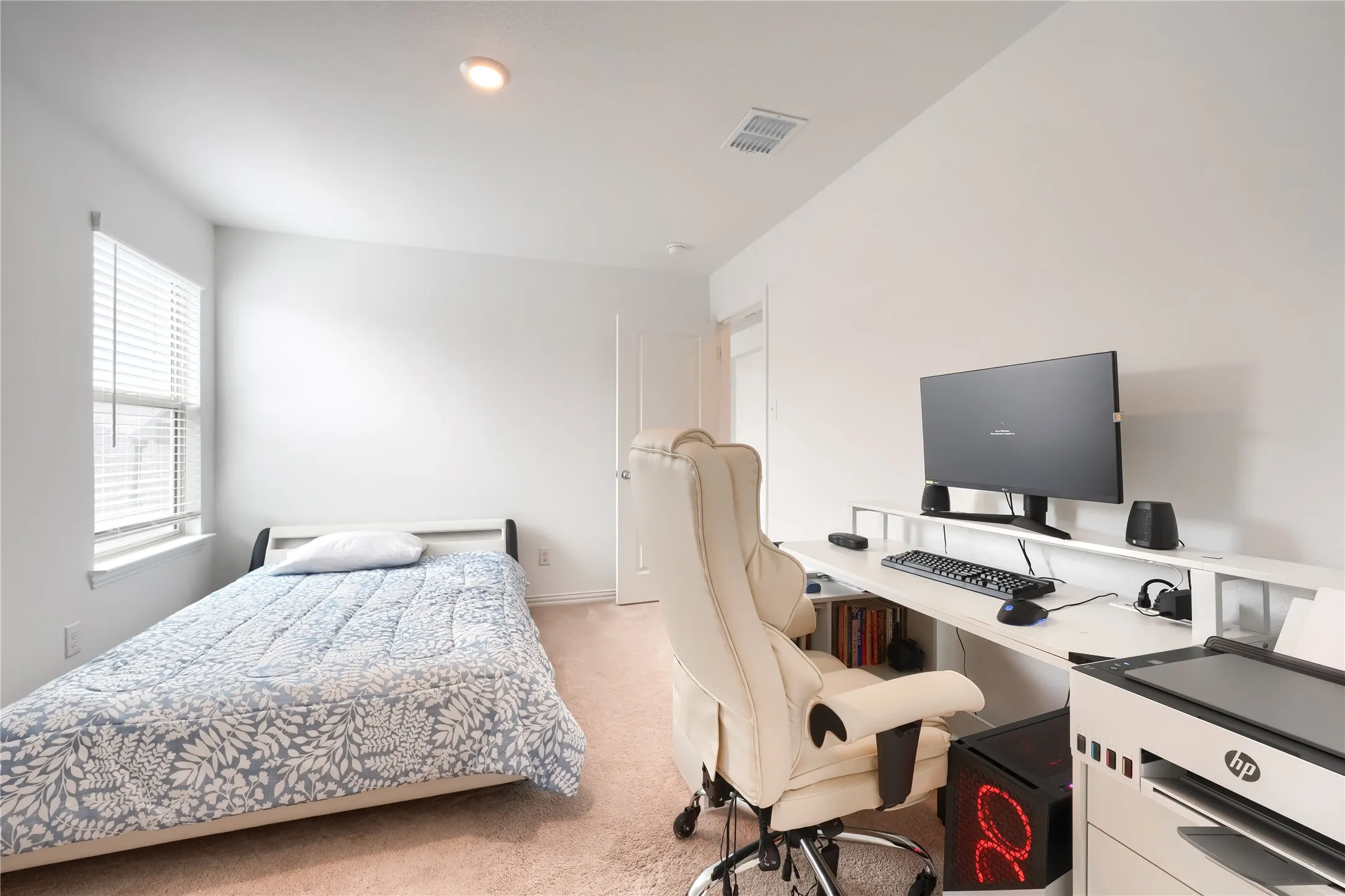 Recessed ceiling lighting, window with blinds, light-toned carpet flooring, built-in shelving, and a solid interior door