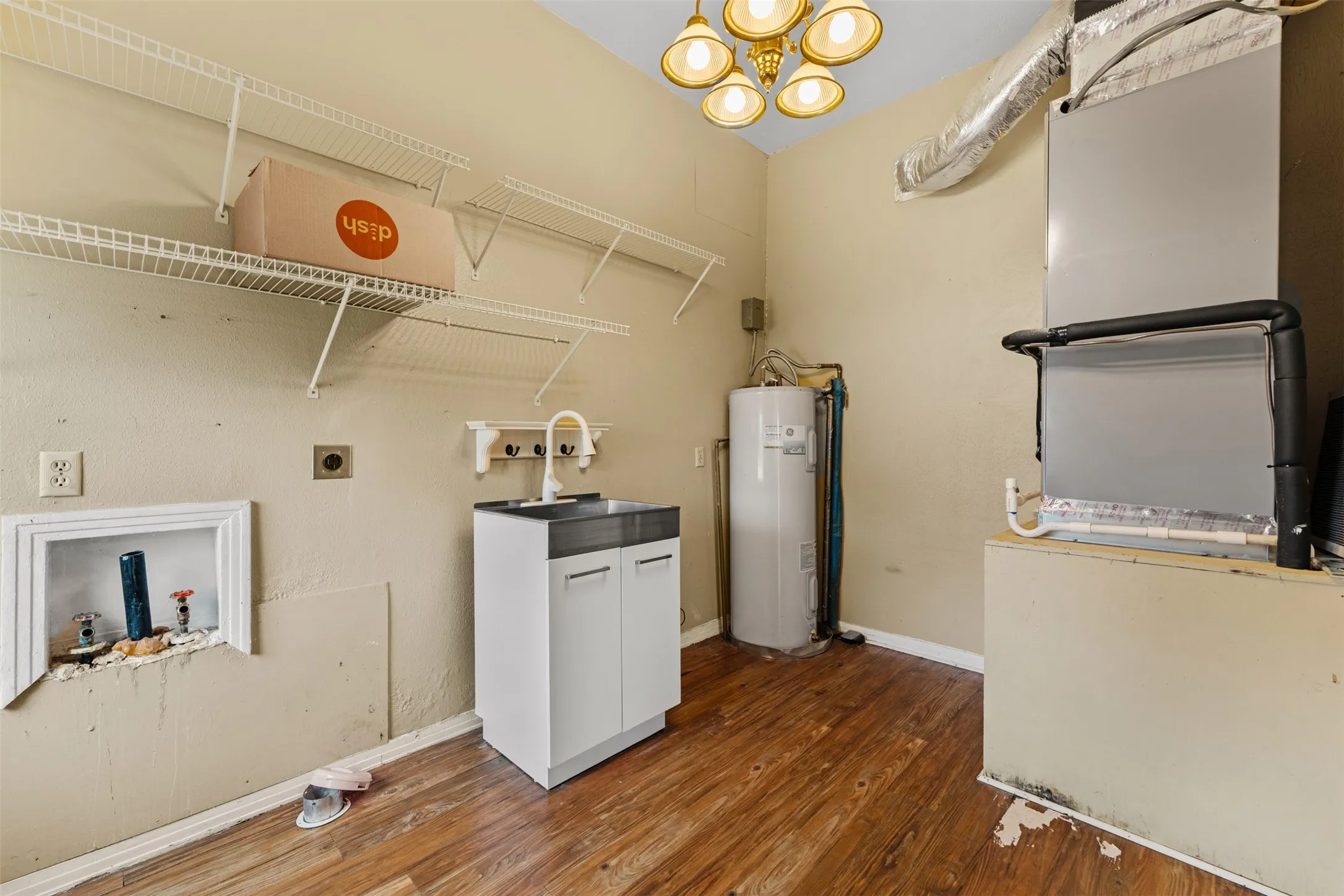 Large utility/laundry room with sink and shelving