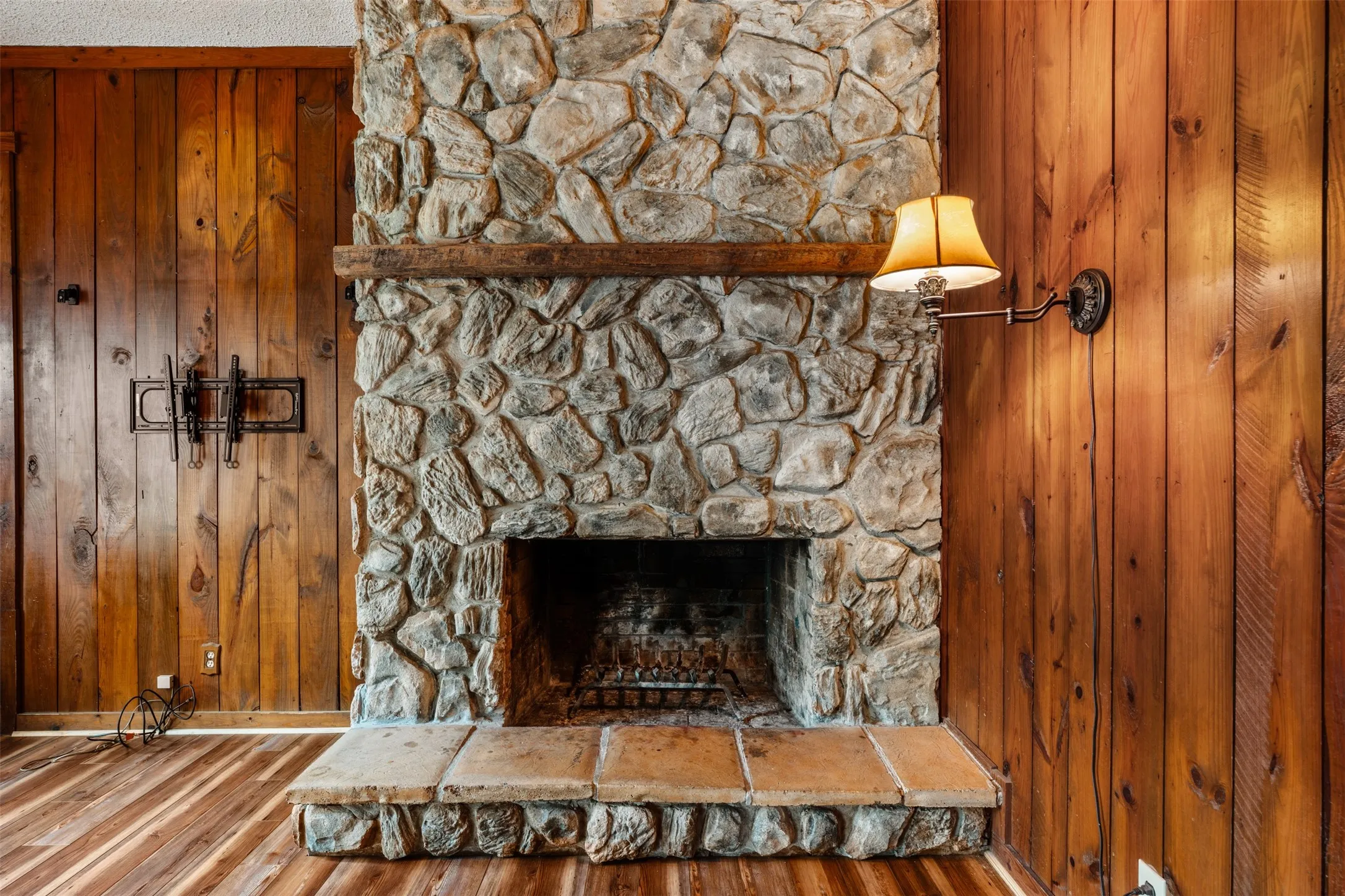 Beautiful floor to ceiling rustic woodburning fireplace in the family/den room
