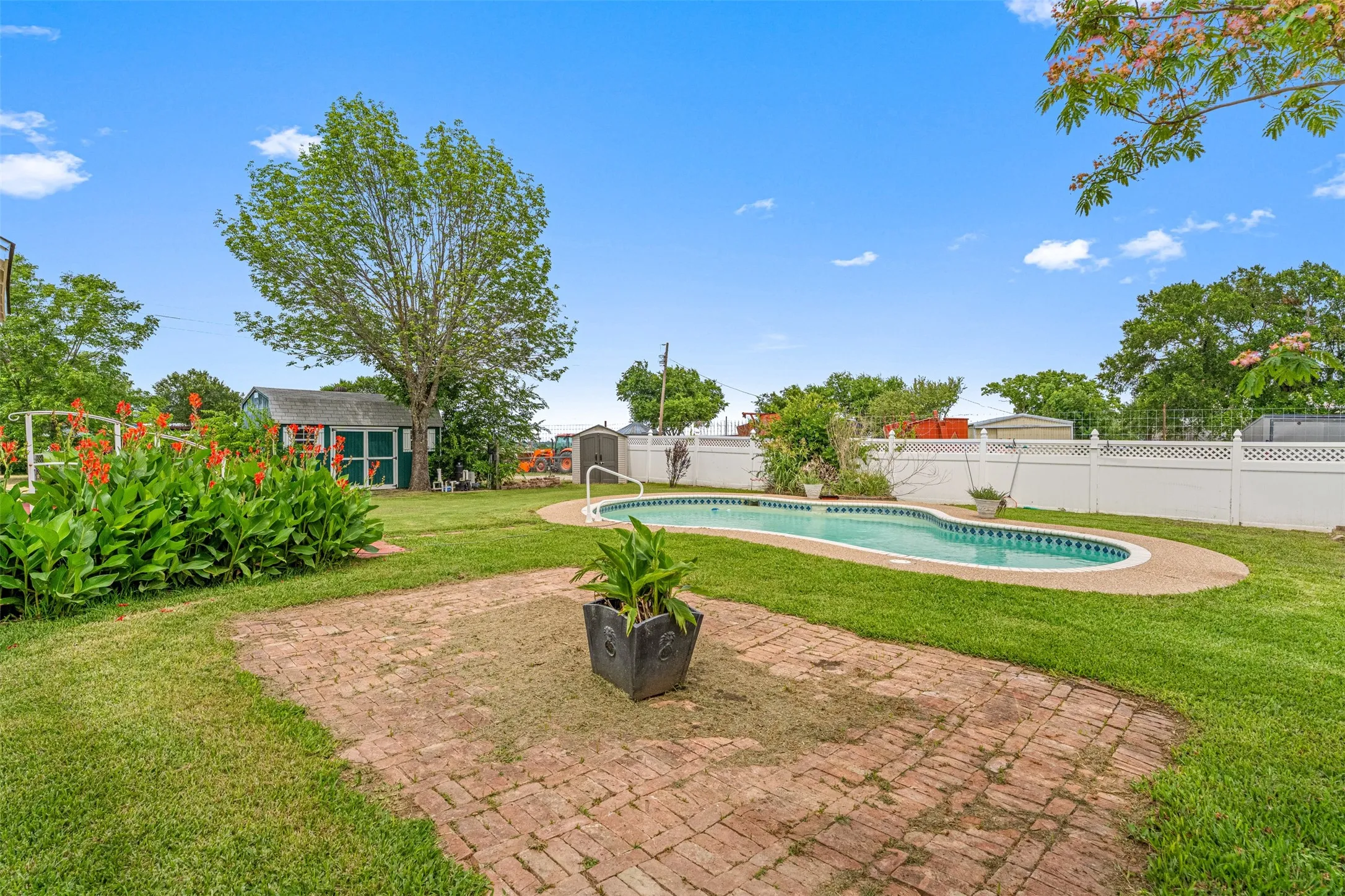 Views of the backyard areas, large brick platform great for patio furniture and grilling