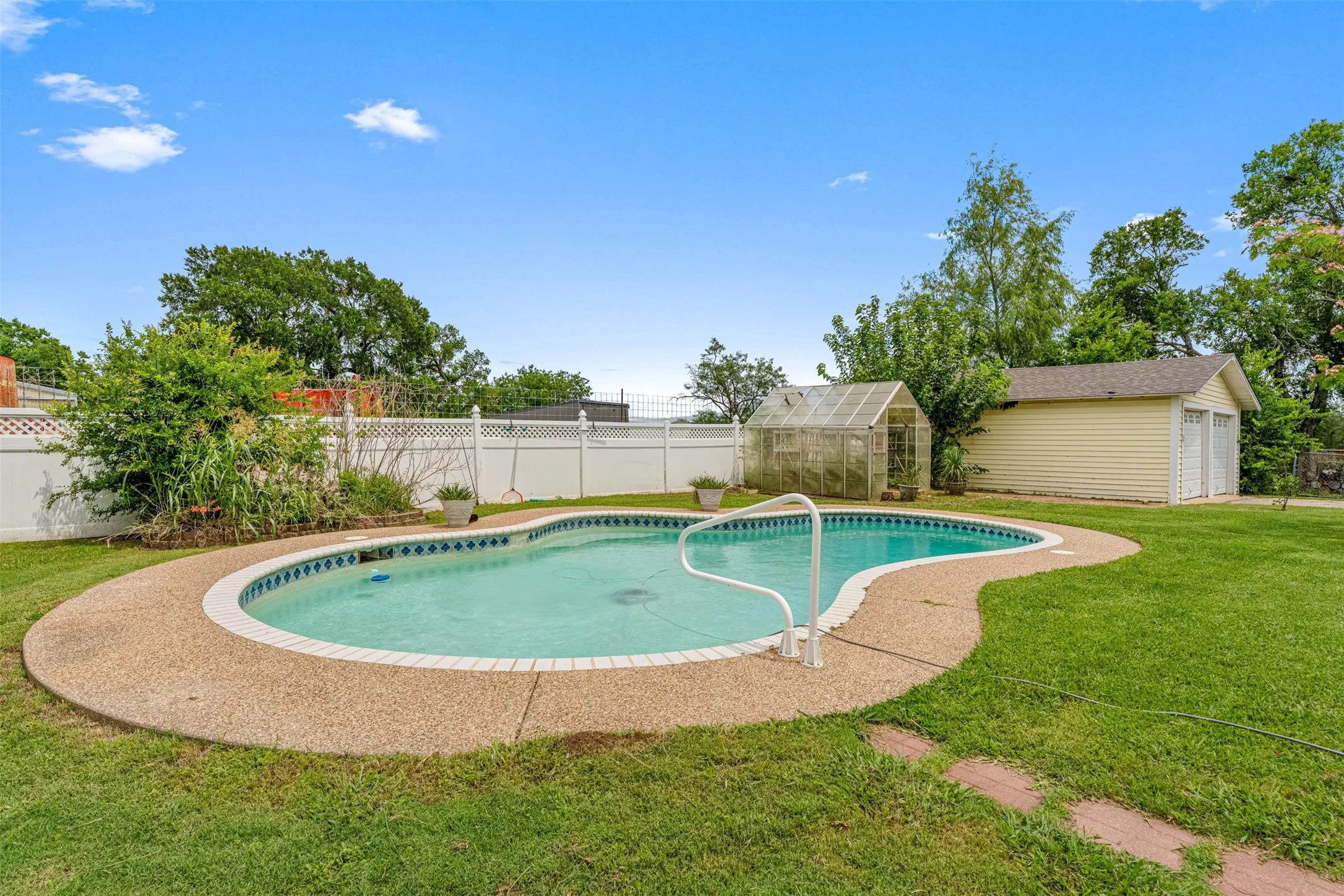 Views of the inground pool SOLD AS-IS, greenhouse, and detached garage