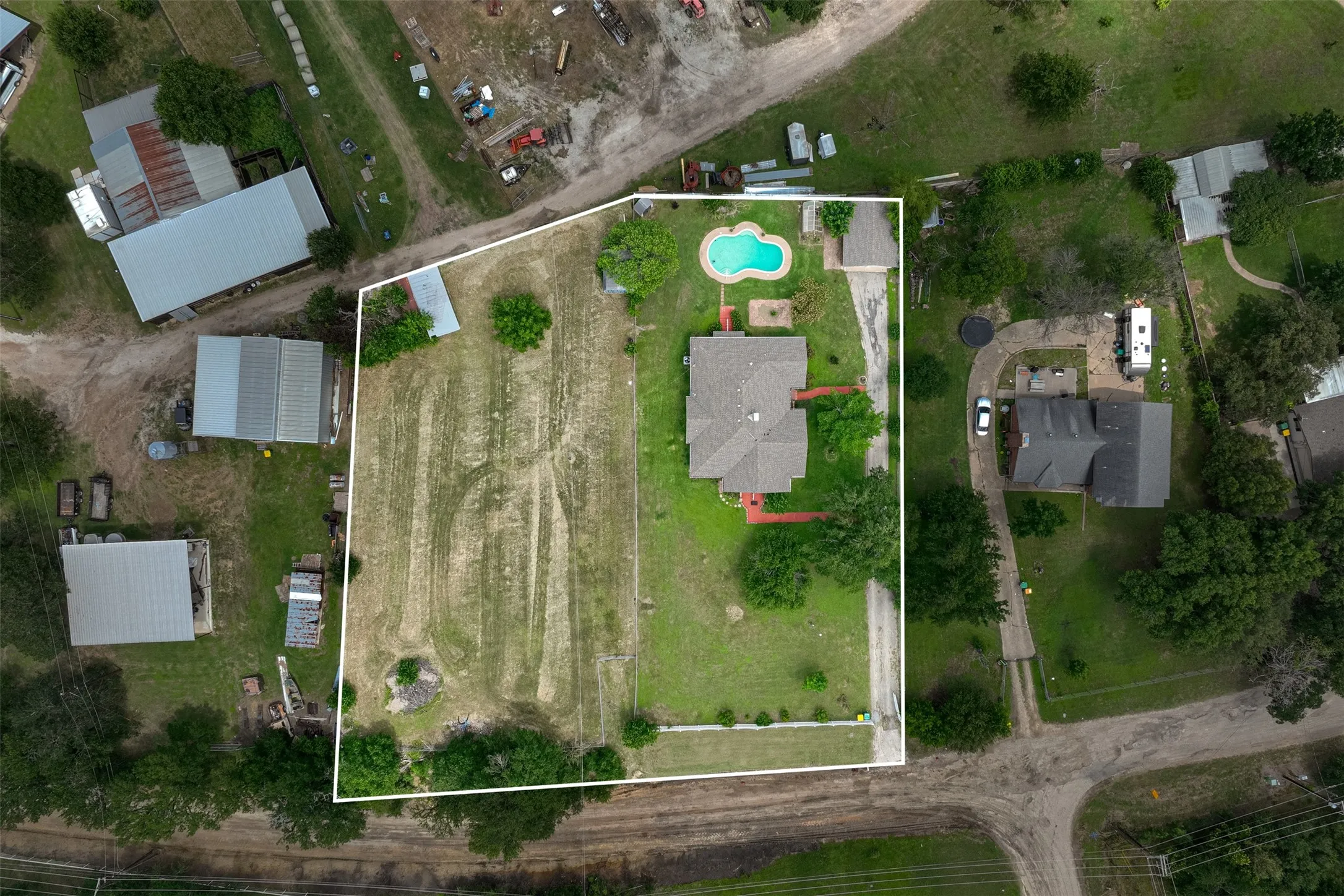 Aerial View of the property, an individual ranch owner owns the surrounding property at back and left side. Individual property owner on right side