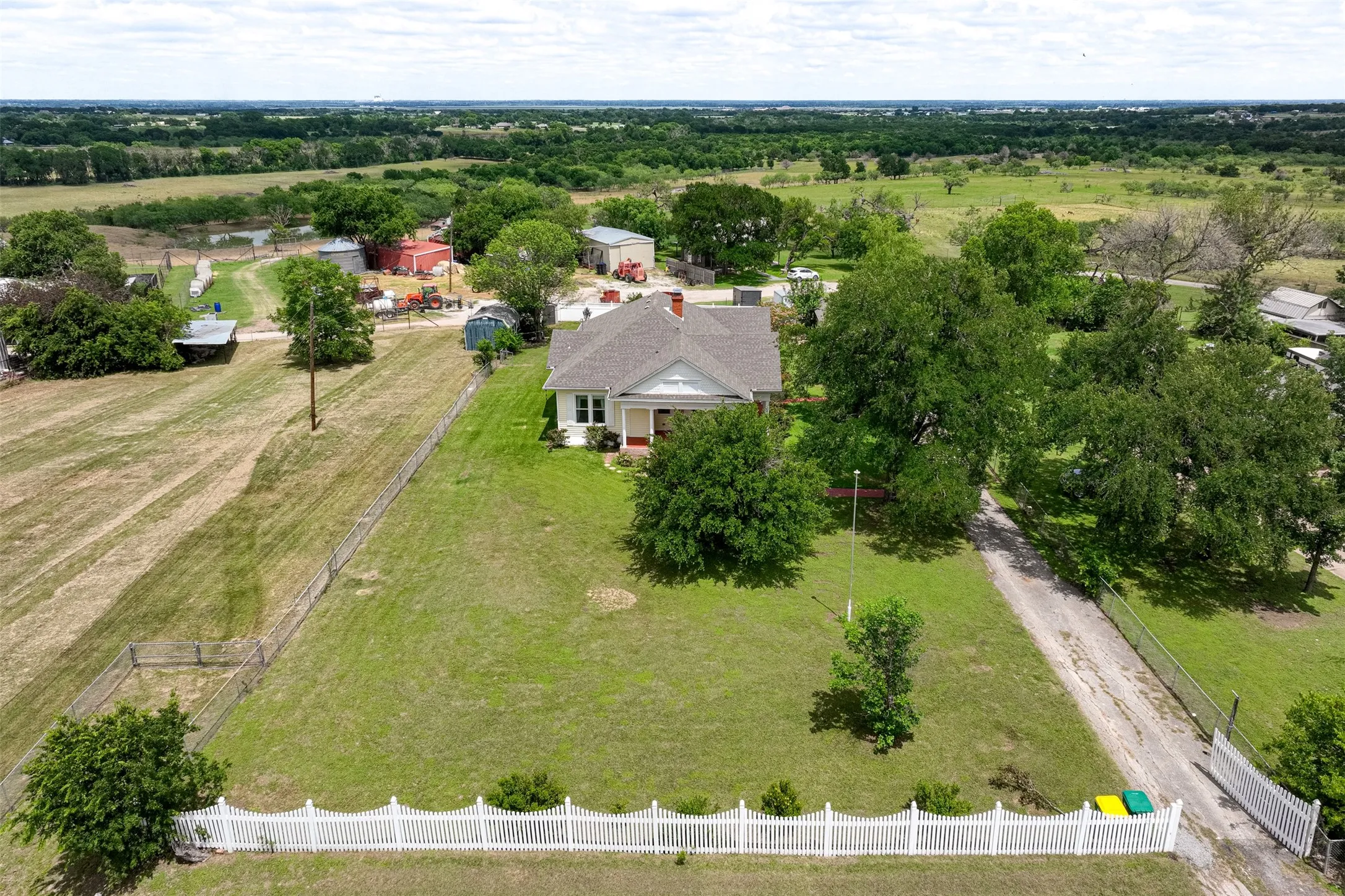 Beautiful Aerial Views of the property, note the white fence with a remote electronic gate