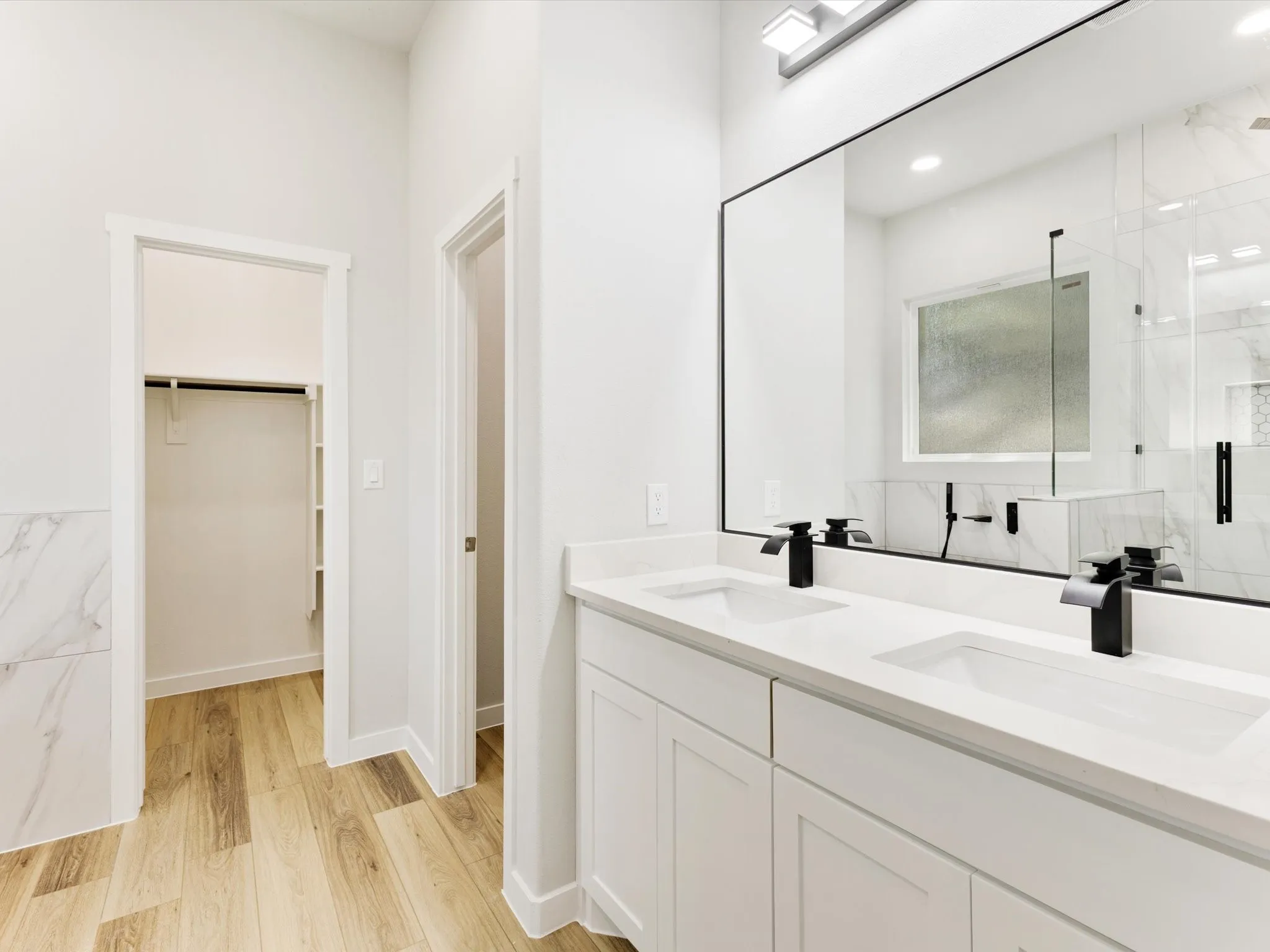 Dual vanity with integrated sinks, quartz countertops, and matte black fixtures