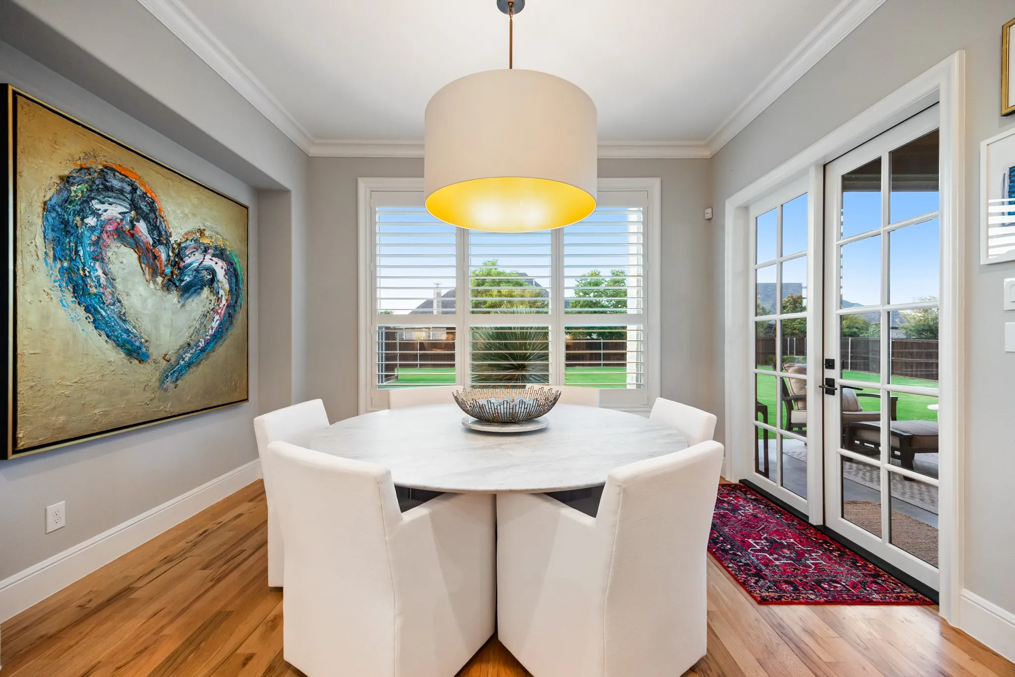 Breakfast nook bathed in morning light, with french doors leading straight out to the patio.