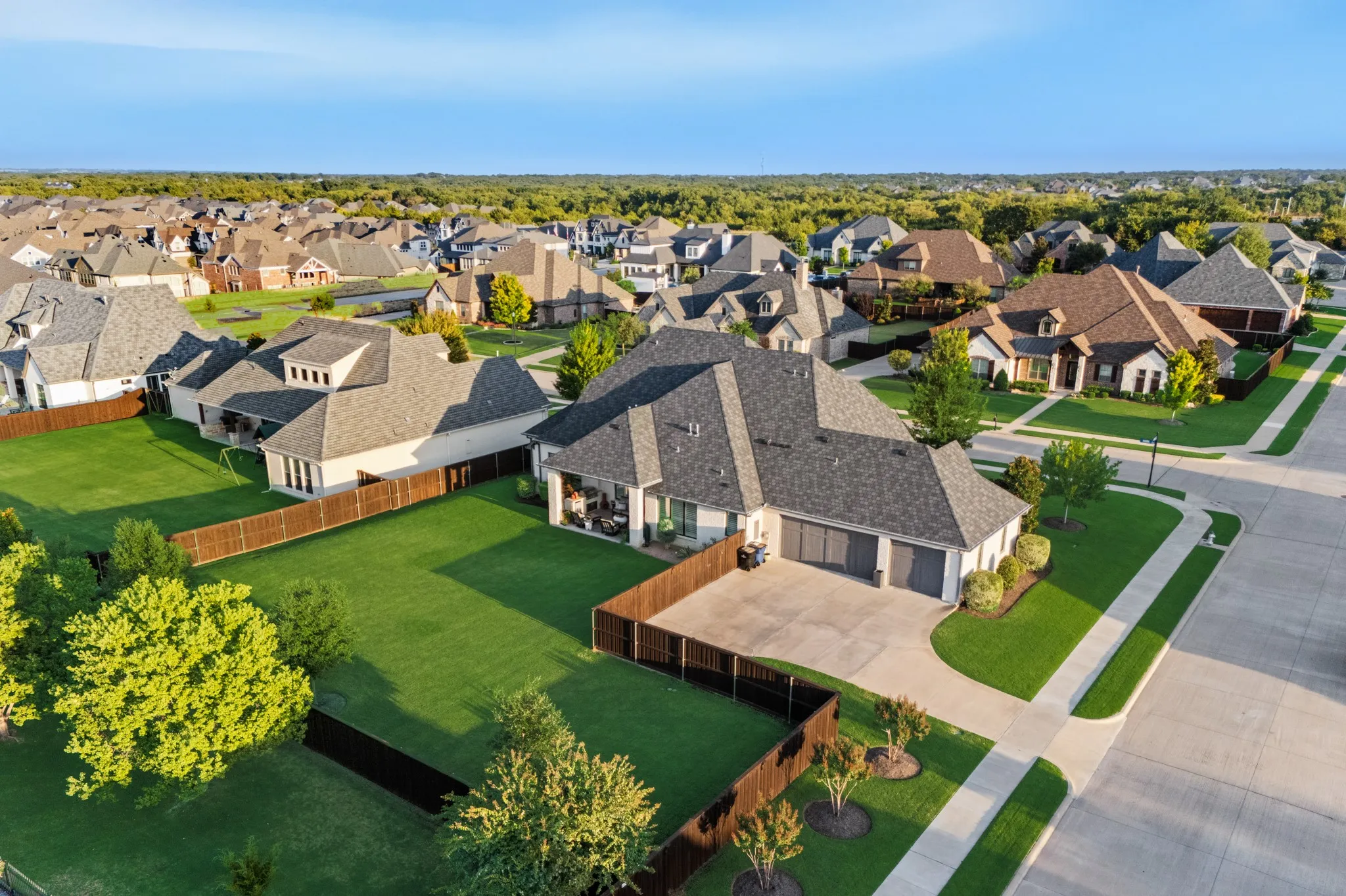 Aerial view highlights the home's setting and 3-car garage