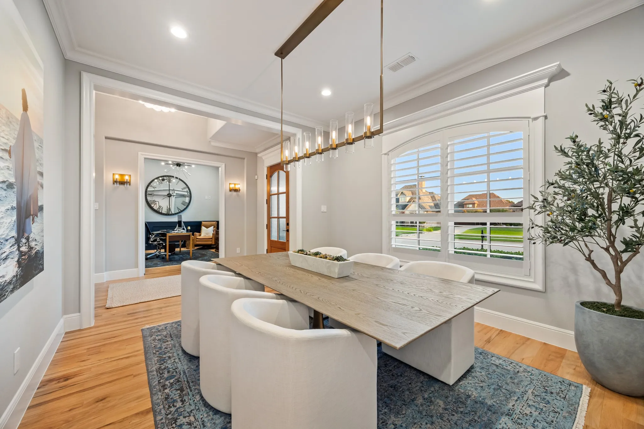 Formal dining space tucked beside the kitchen, with yard views through oversized windows.