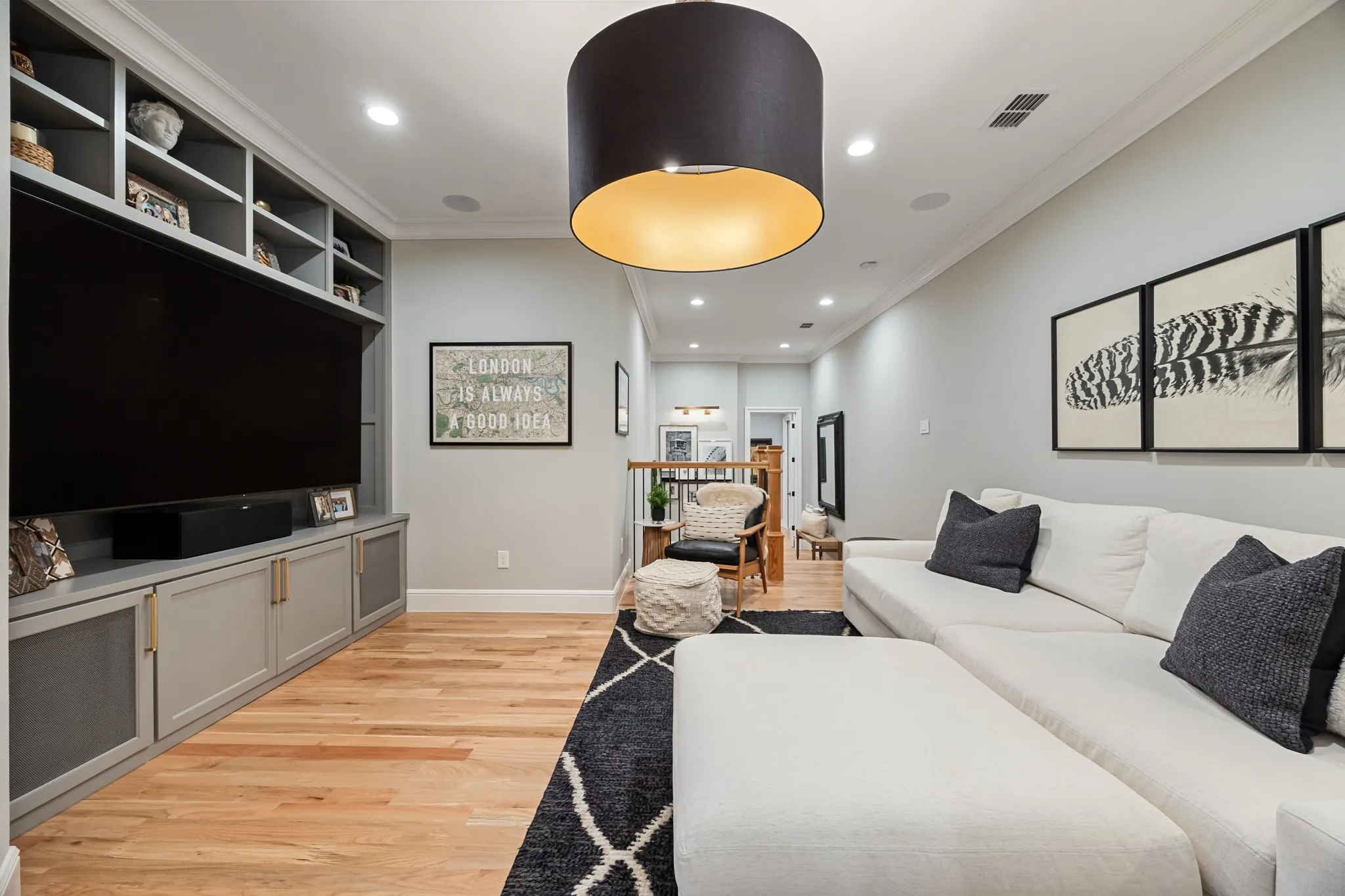 Family loft finished with custom built-ins and surround sound, made for movie nights.