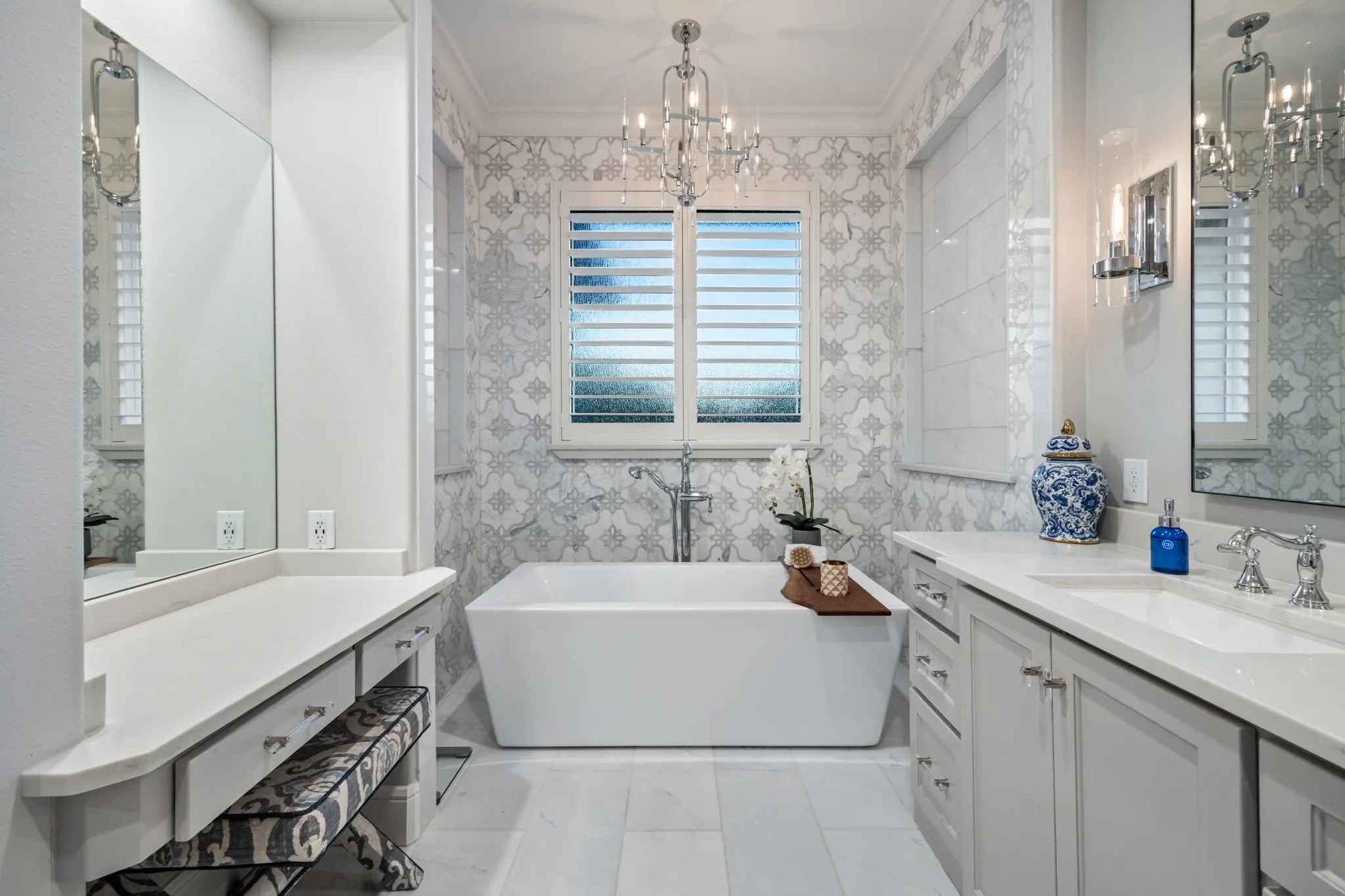 Soaking tub set beneath a shuttered window makes for a true spa-day escape.