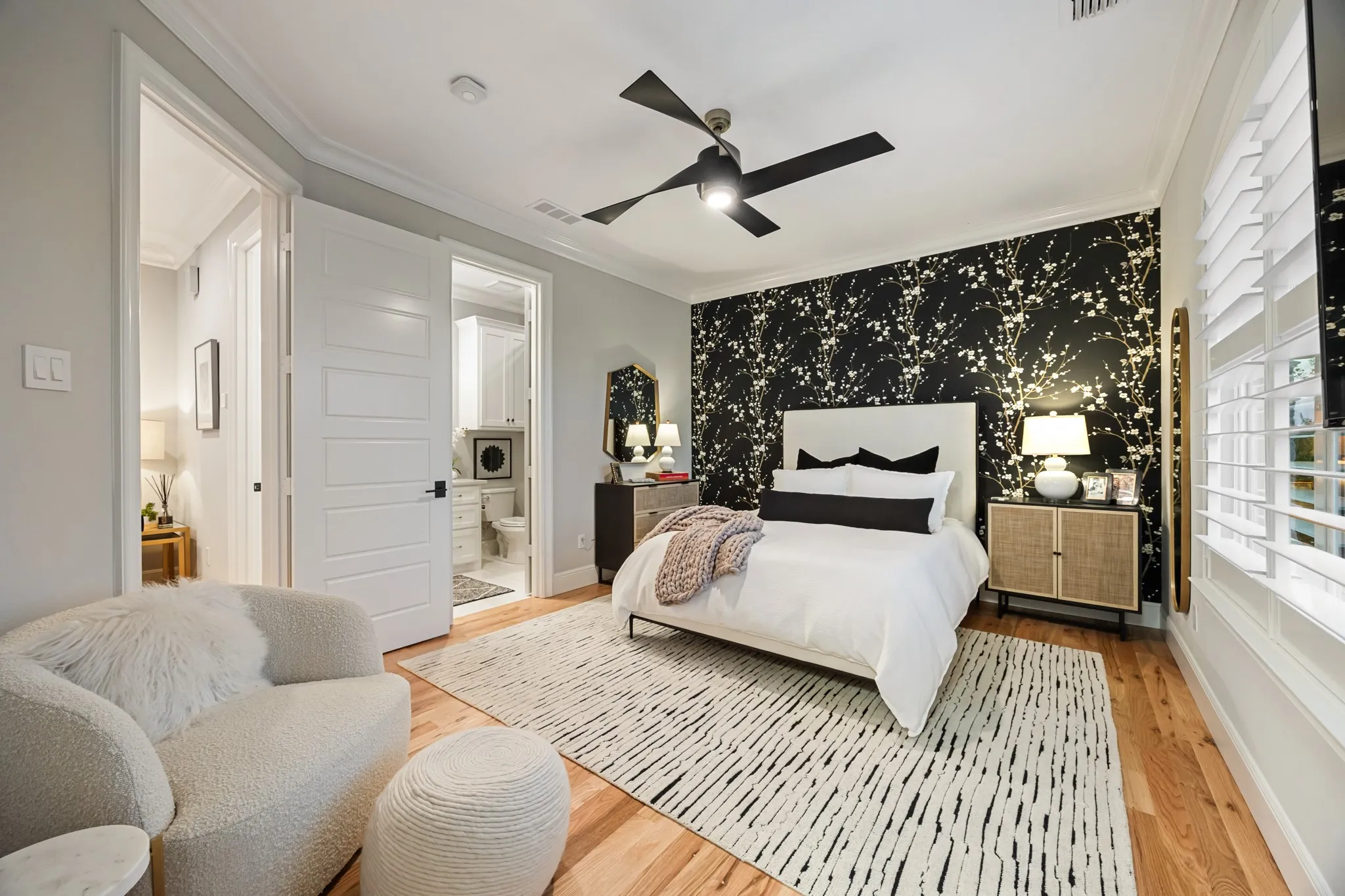 Upstairs bedroom finished with oak hardwood flooring and a bold accent wall.
