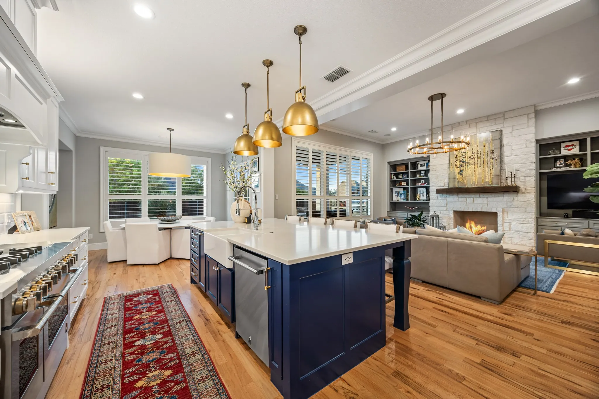 Chef's kitchen centered on an oversized island, finished with JennAir appliances and Restoration Hardware pendant lighting.