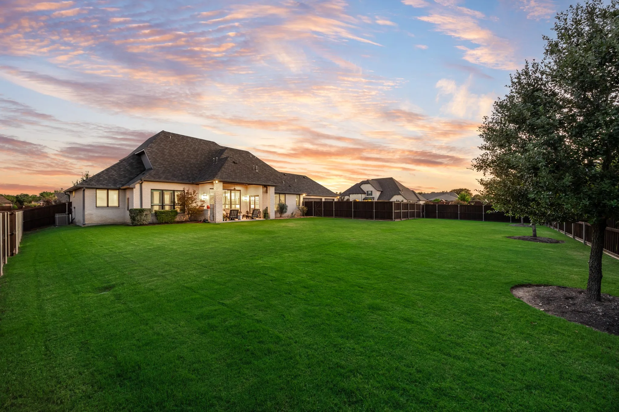 Nearly half an acre of lot space, framed by trees at along the fence.