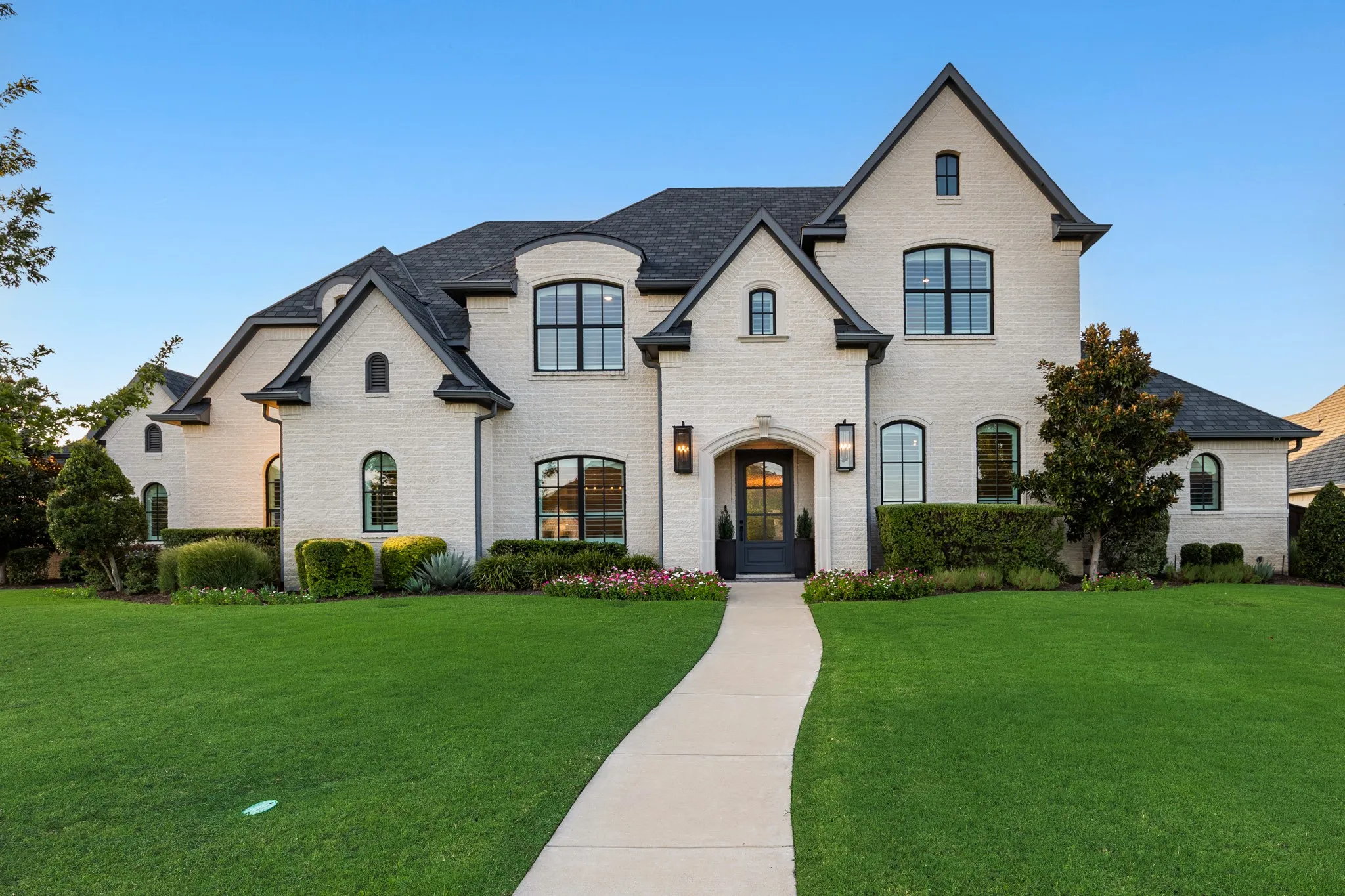 Custom Troy Priddy home makes a striking first impression with its stone-and-stucco facade.