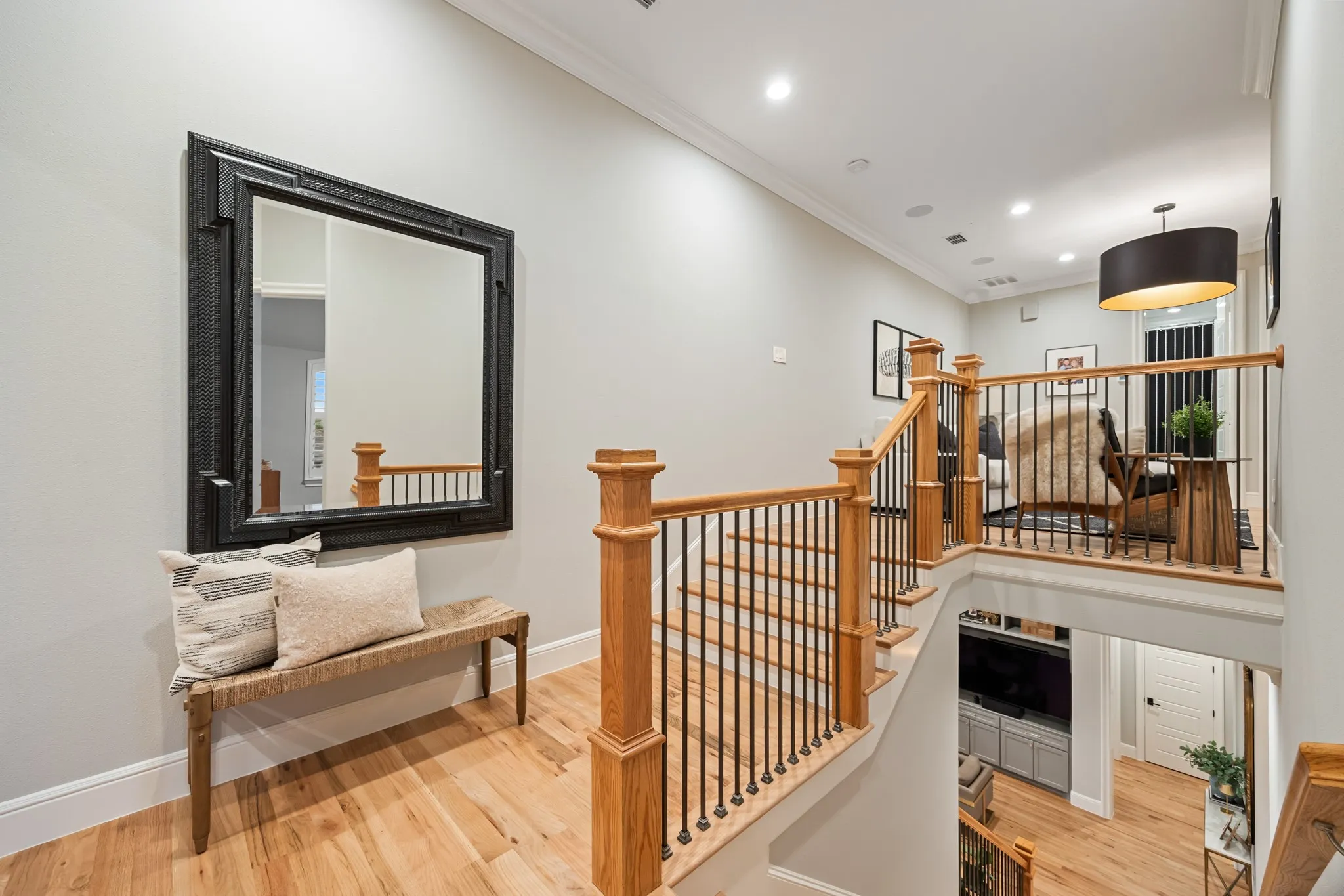 Upstairs landing overlooks the stairway, connecting the bedrooms and loft above.
