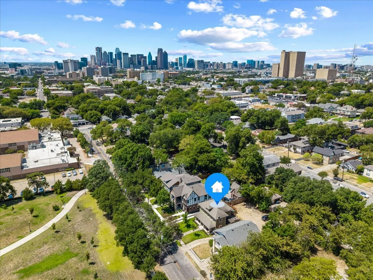 Urban setting with a prominent city skyline, residential street, and green spaces