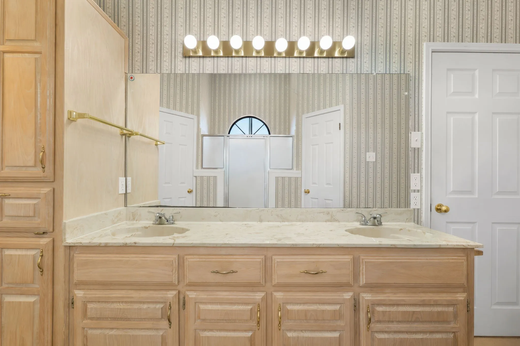 Dual vanity with light-tone cabinetry and integrated sinks
