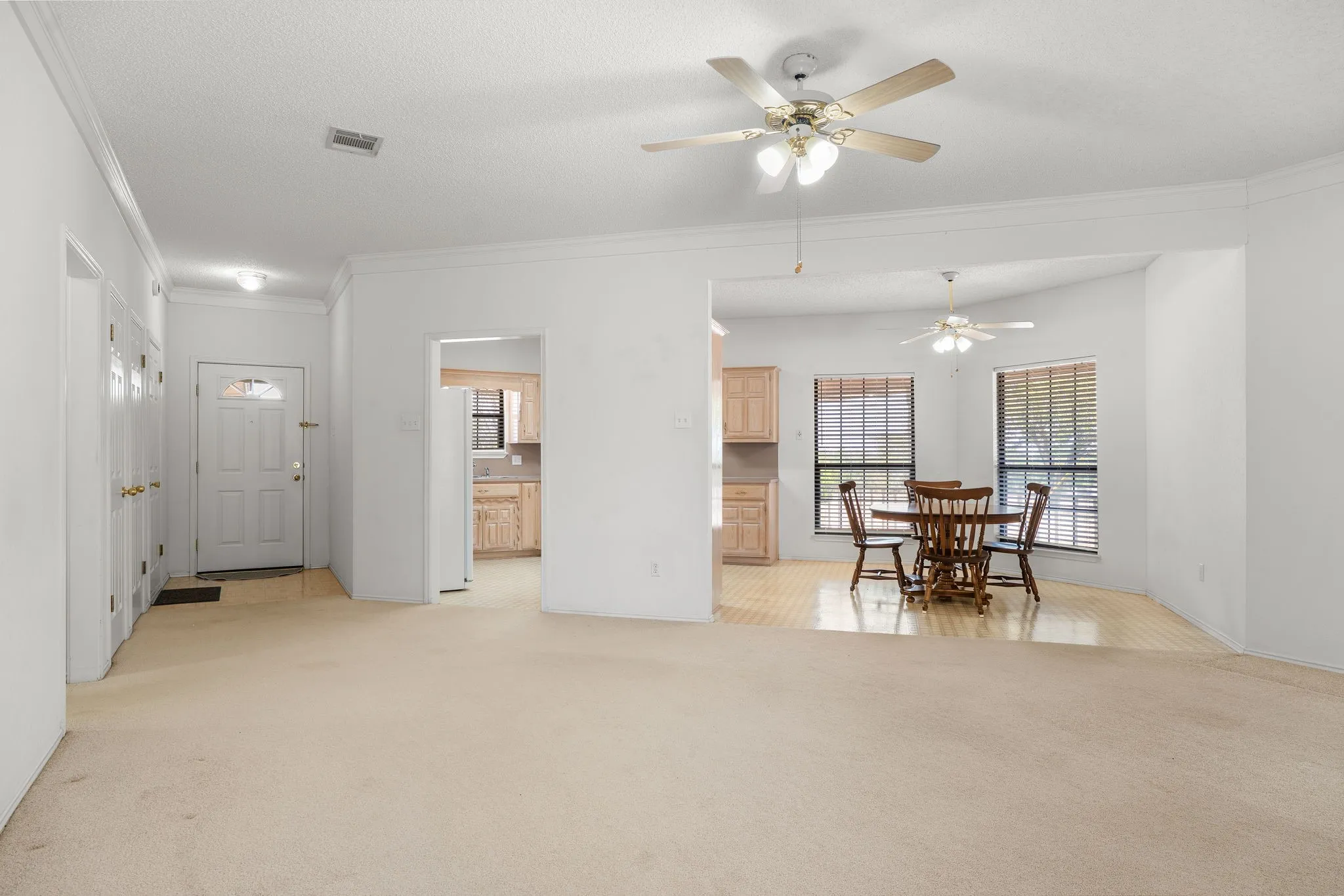 White walls throughout with carpeted flooring in the main area