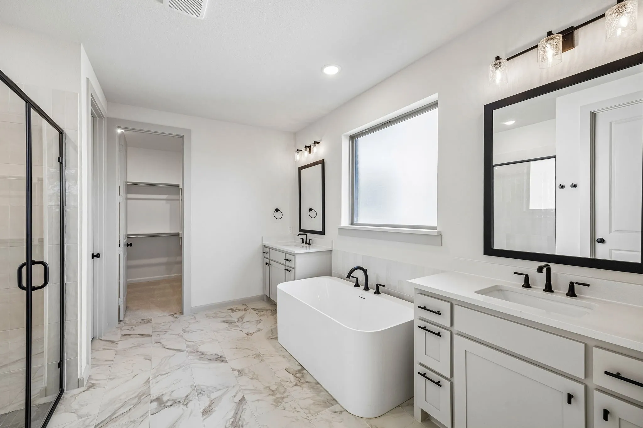 Filled with style and offering plenty of room for two, this owner's bath is the perfect place to start or end your day!