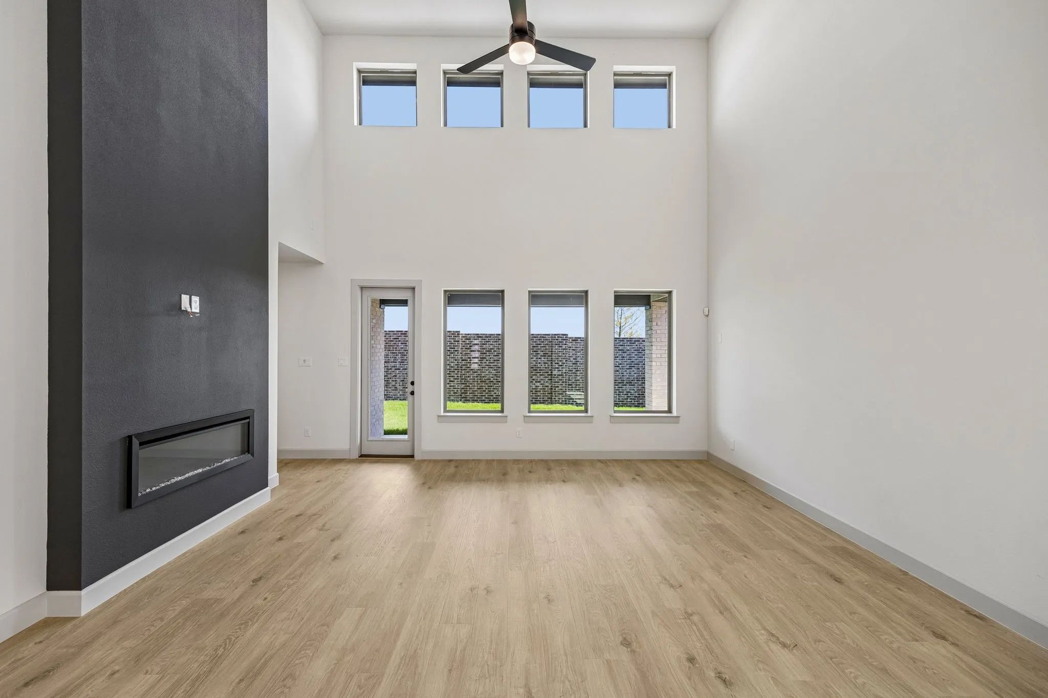Dual story windows flood this family room with natural light!