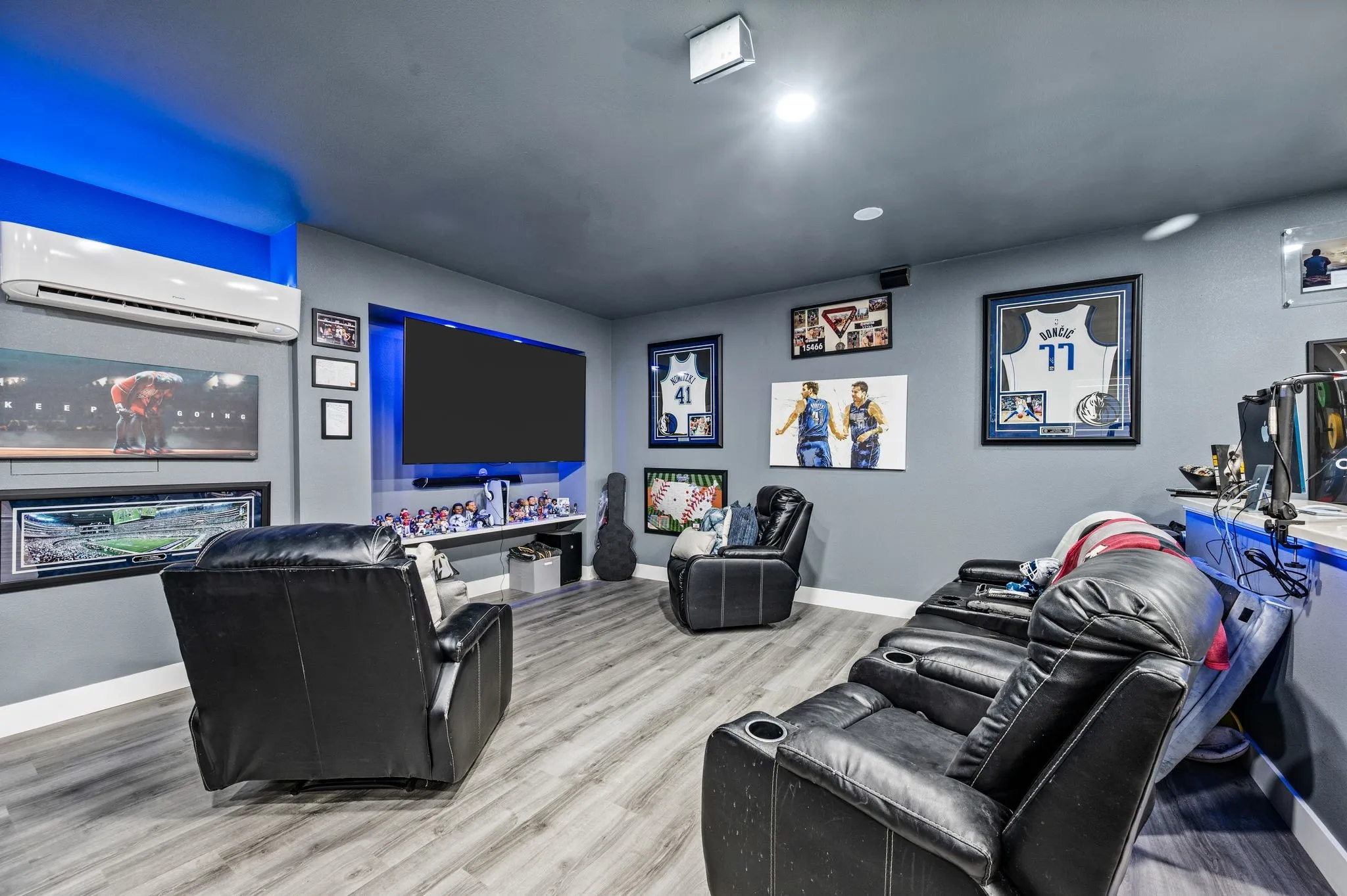 Entertainment room featuring wood-finish flooring, recessed lighting, and wall-mounted air conditioning unit
