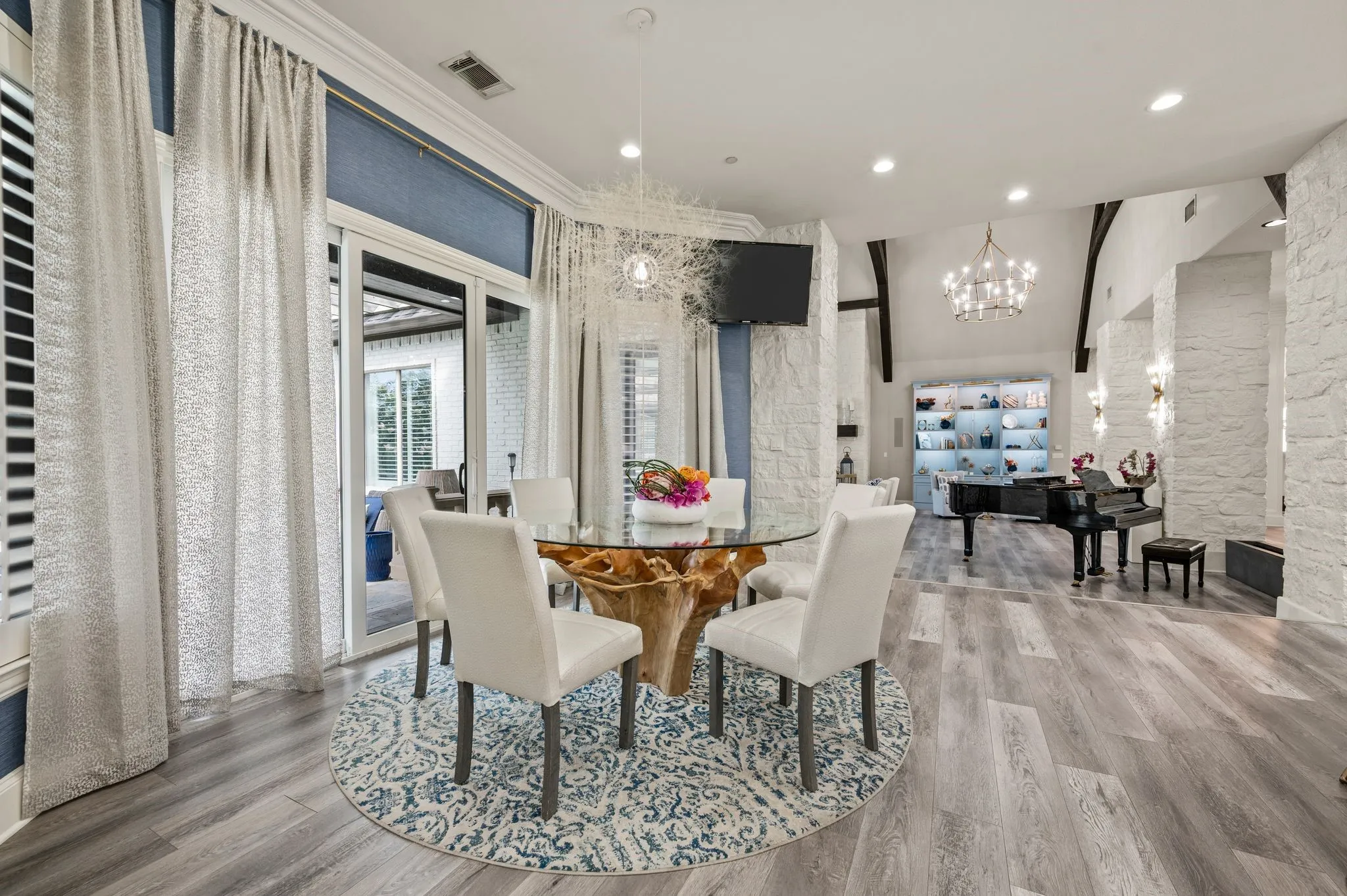 Spacious interior featuring wood-finish flooring and white stone accent walls