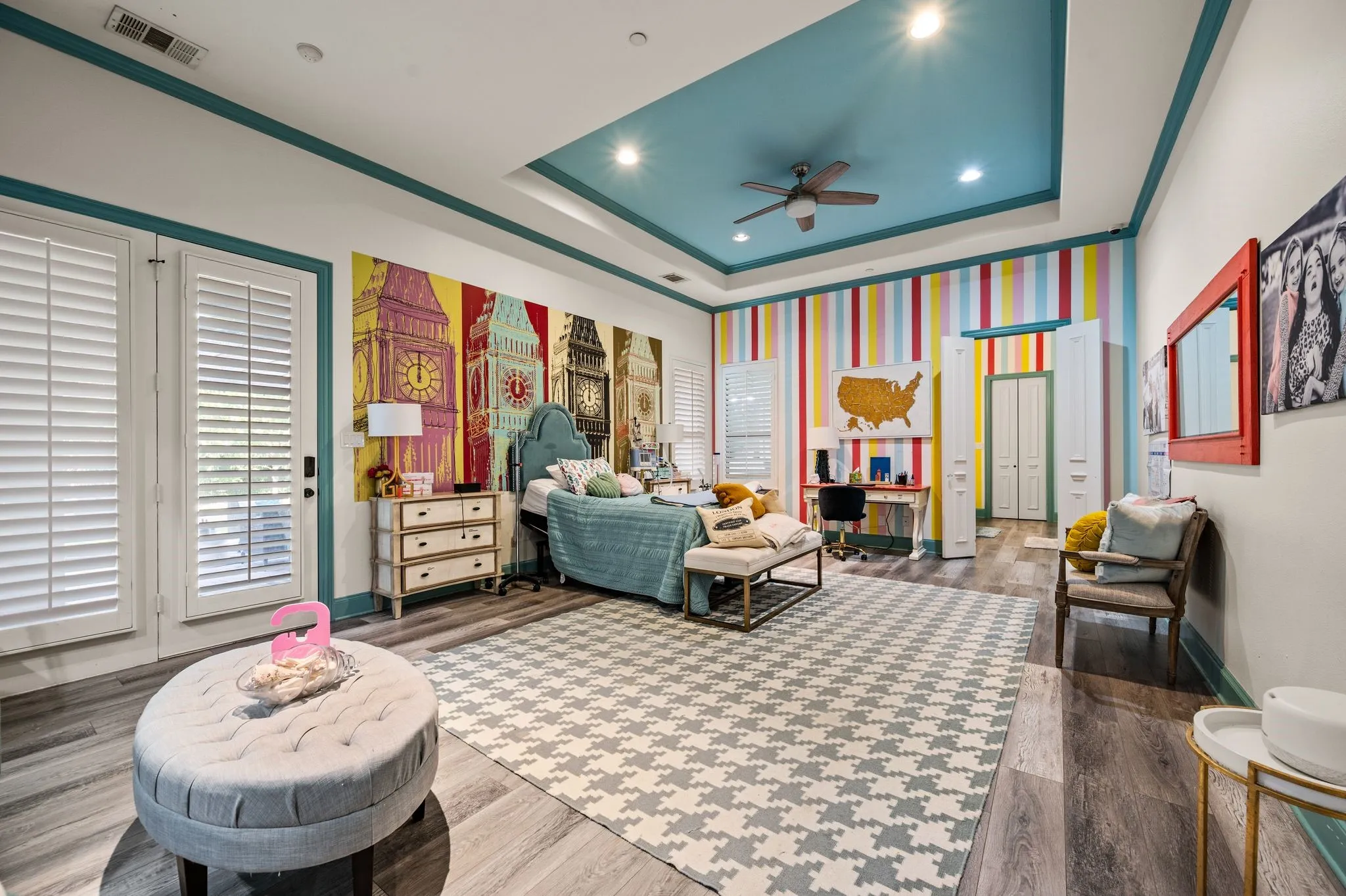SECOND Primary suite featuring wood-finish flooring, a tray ceiling with recessed lighting, and a ceiling fan