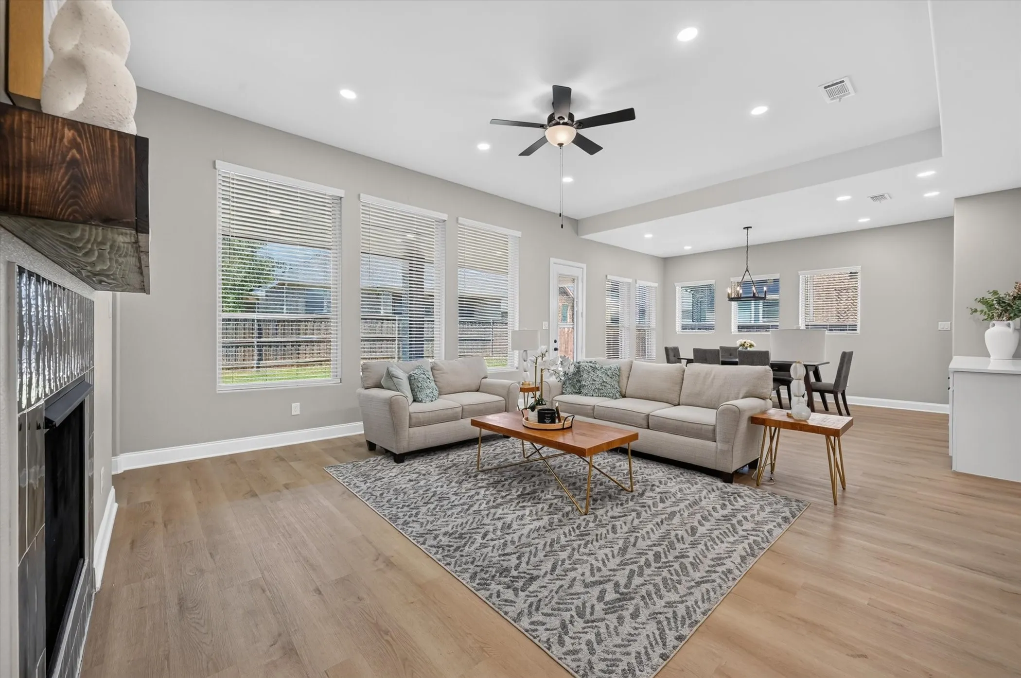 Spacious living area featuring wood-finish flooring, recessed lighting, and a ceiling fan
