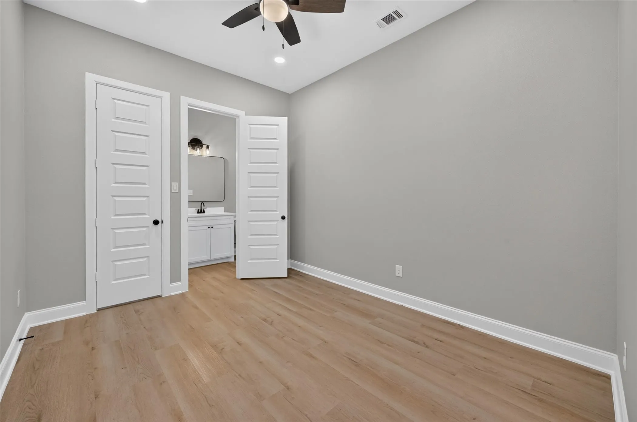 Wood-finish flooring, recessed lighting, and a ceiling fan