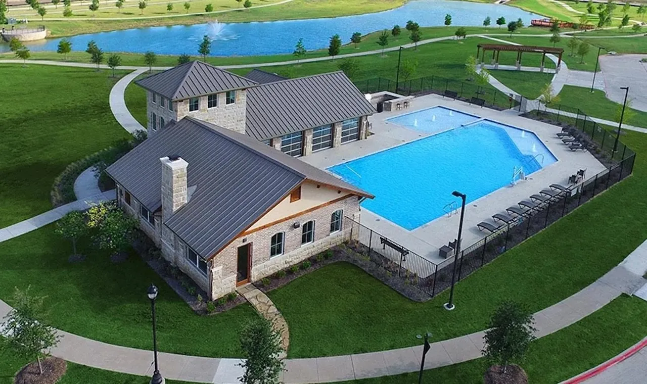 Community pool and clubhouse with expansive surrounding green space