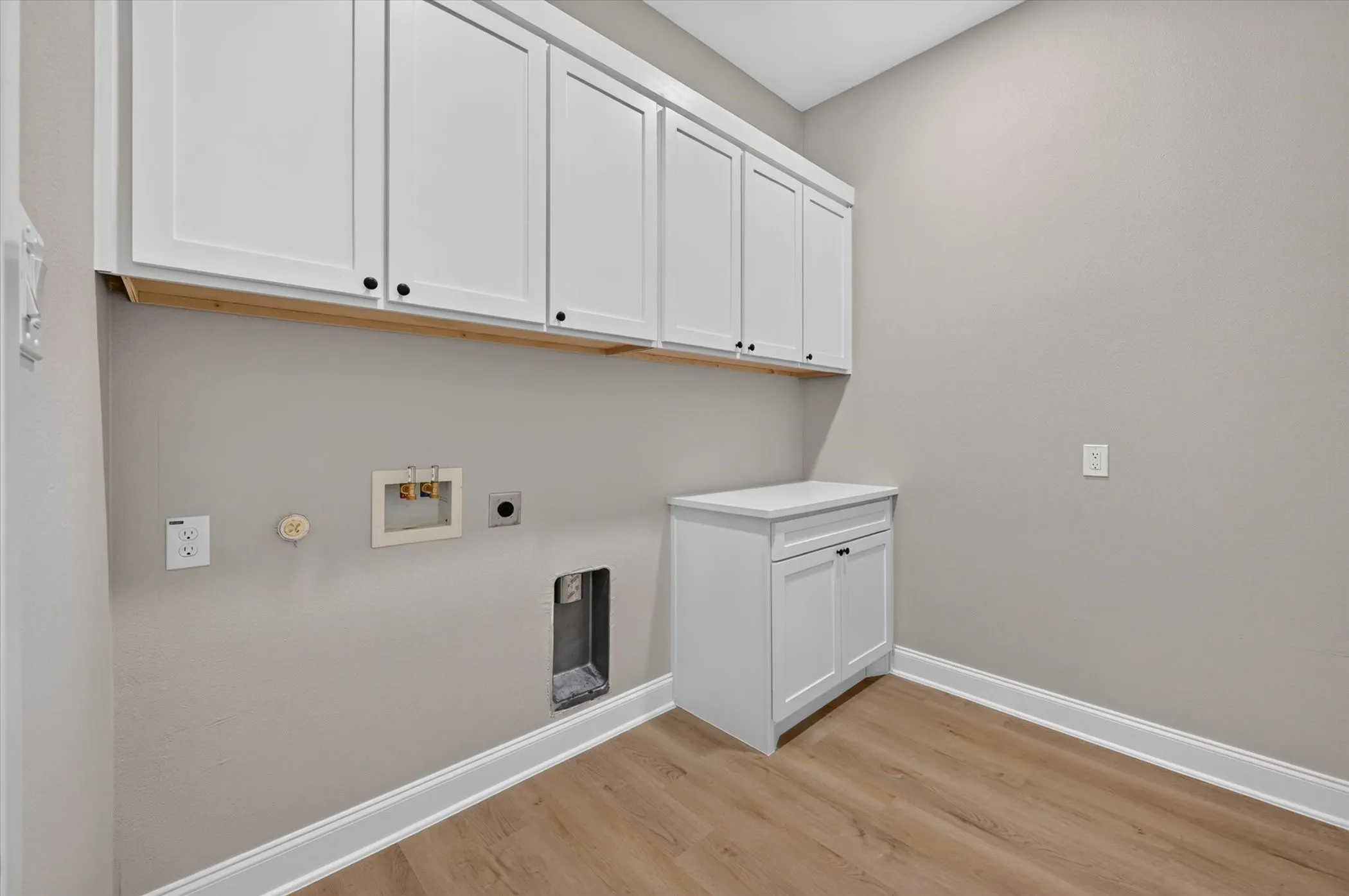 White shaker-style upper cabinetry with black hardware