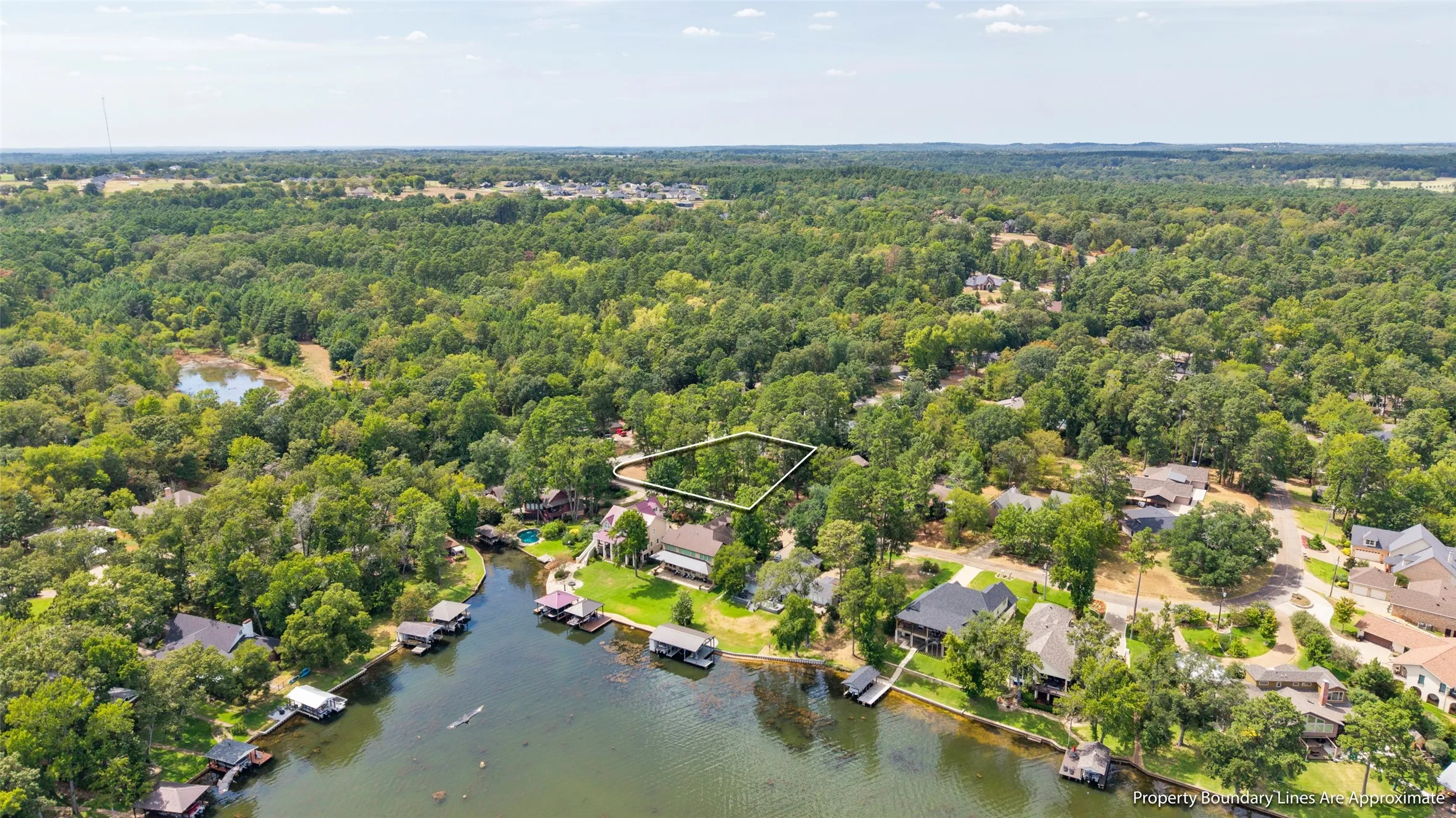 Waterfront estate nestled within mature landscaping and lush woodland surroundings
