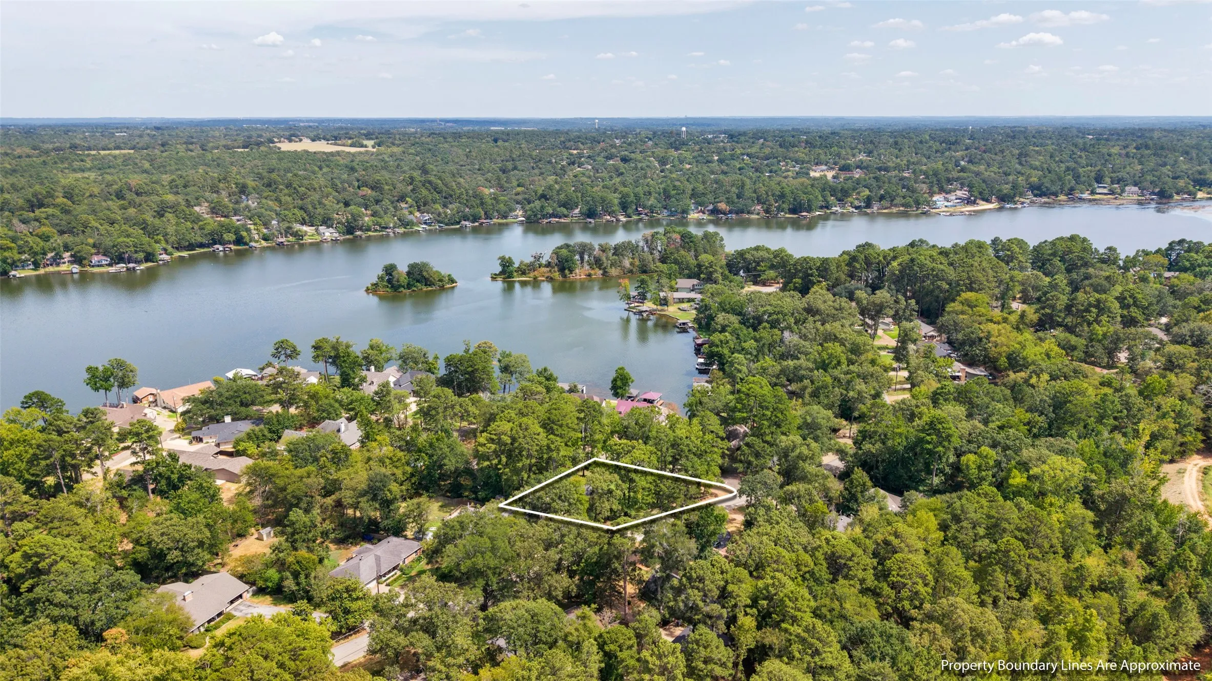 Wooded lot with water frontage, surrounded by mature trees