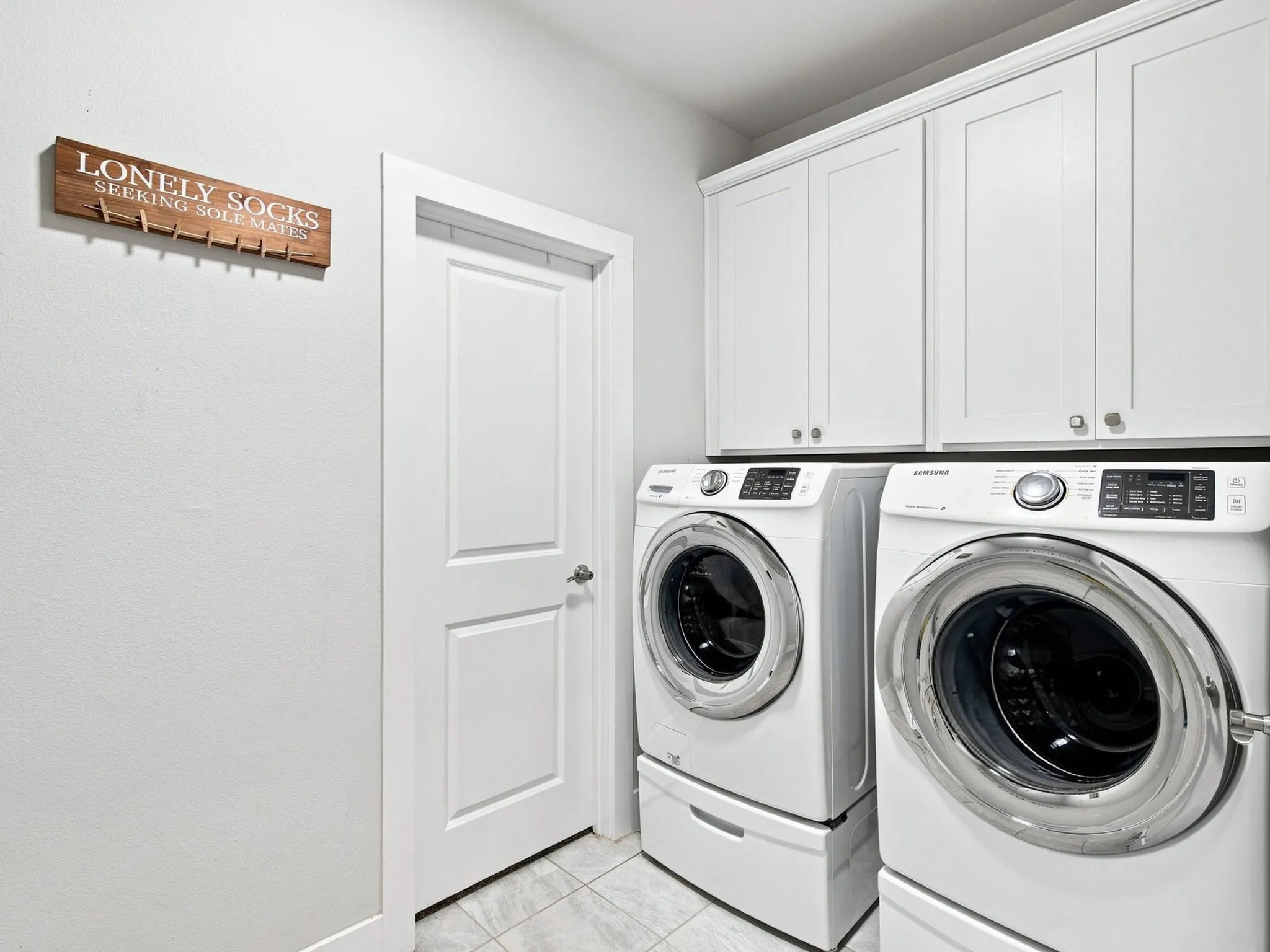 White shaker-style cabinetry with silver hardware