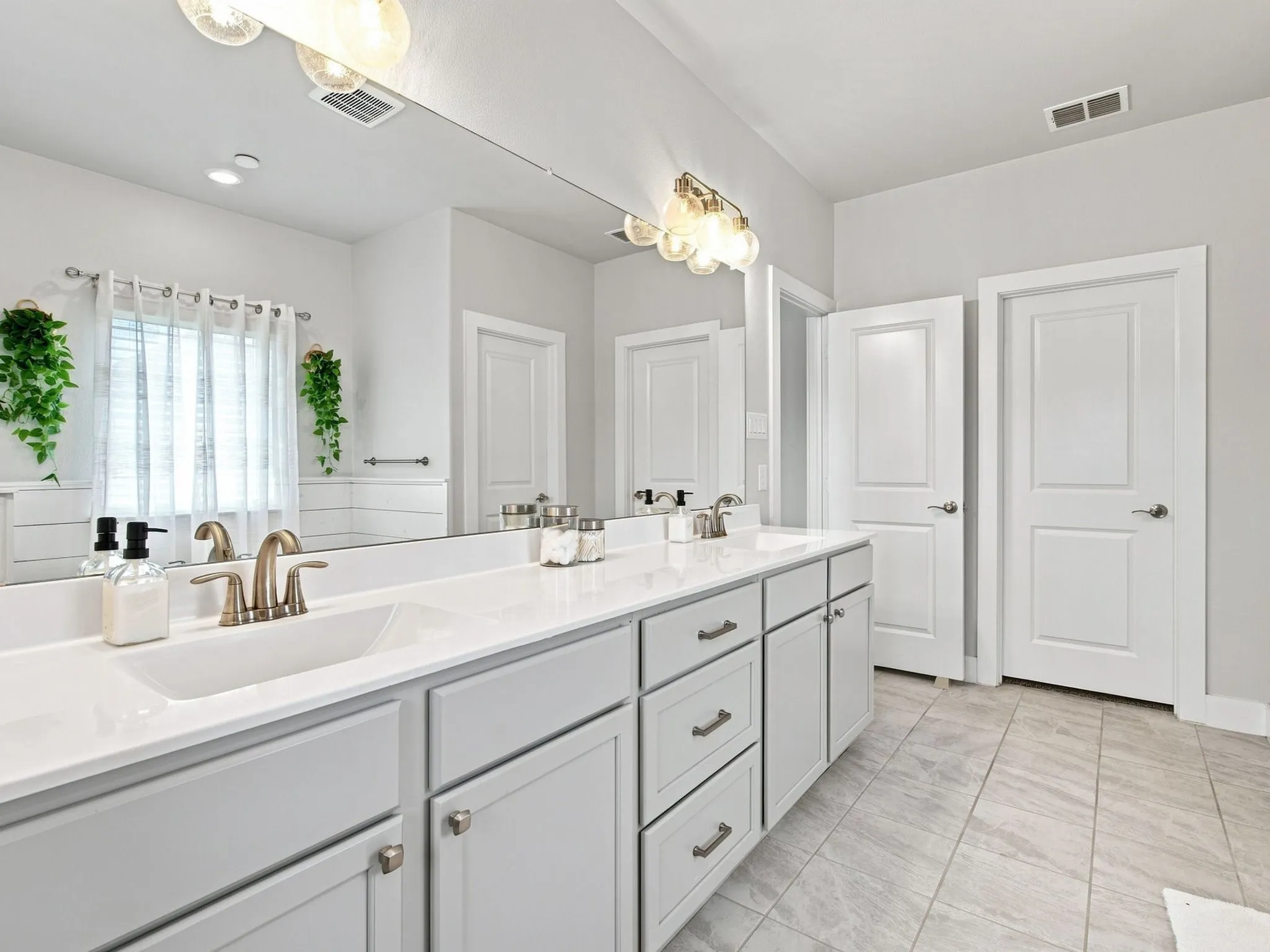 Dual vanity with integrated sinks and brushed nickel fixtures
