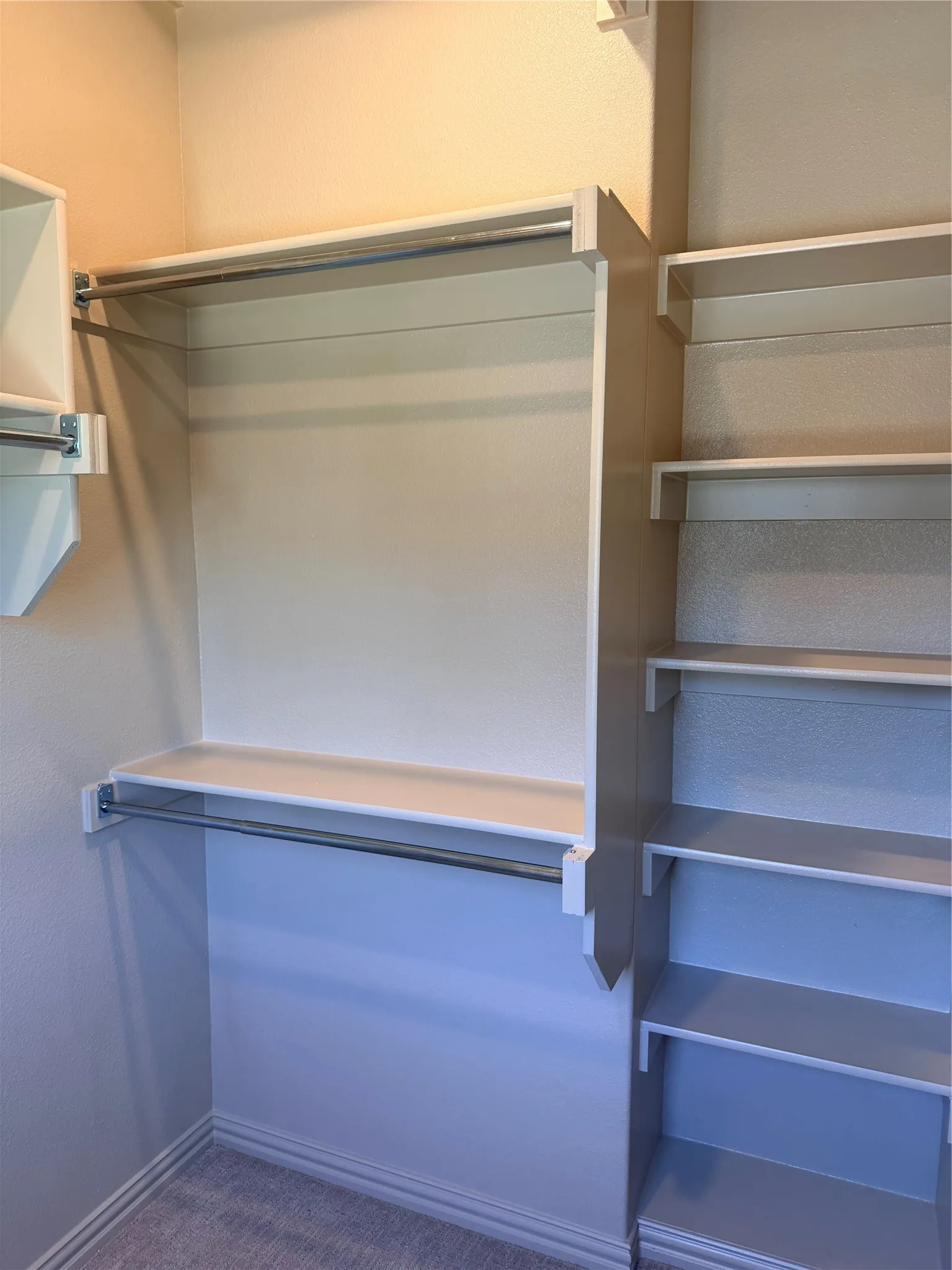 Master closet #1 Custom closet system featuring multiple shelves and hanging rods
