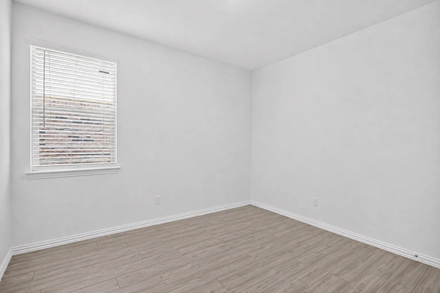 Neutral wall paint complemented by wood-finish flooring