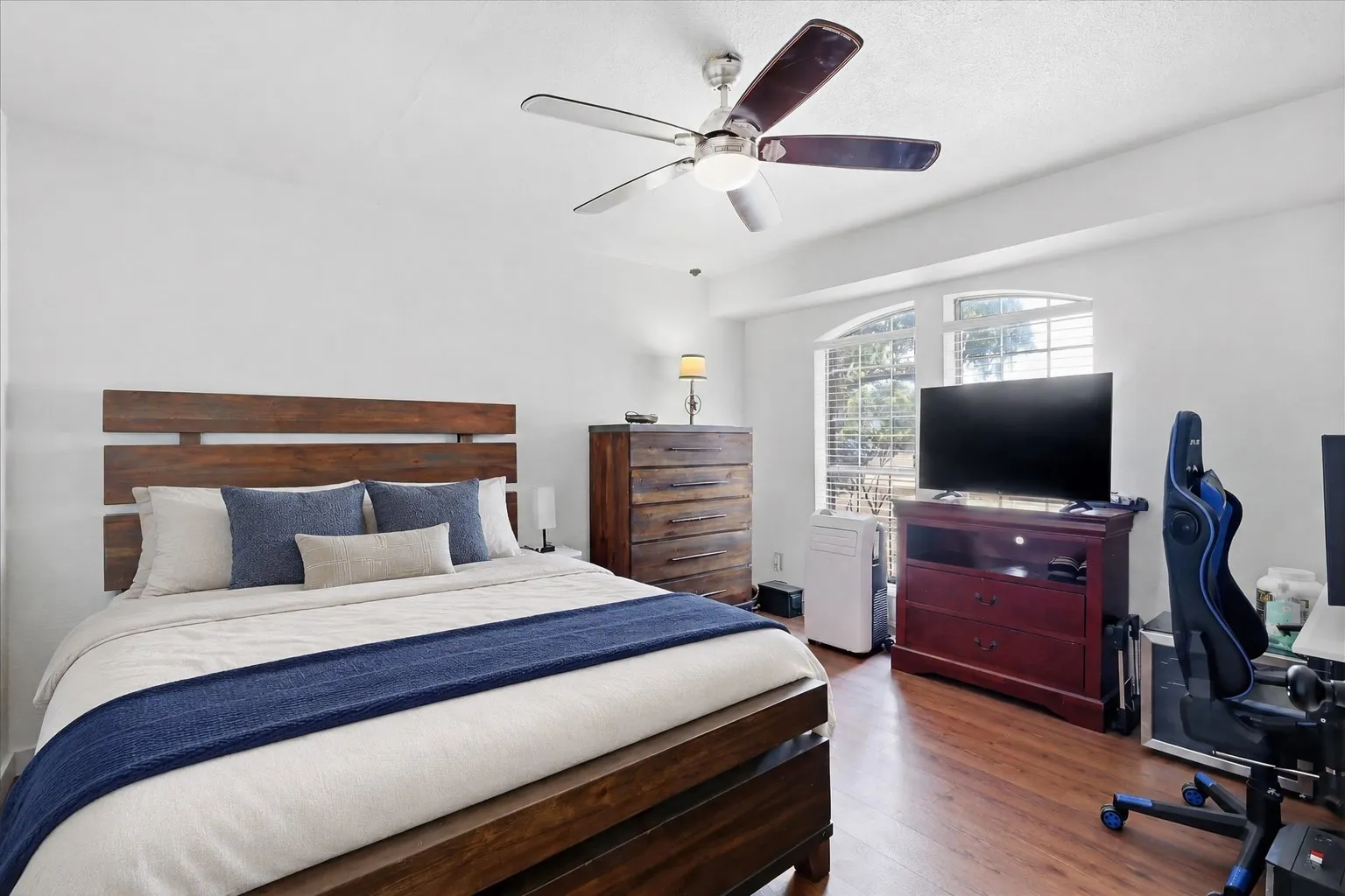 Wood-finish flooring with arched window accents
