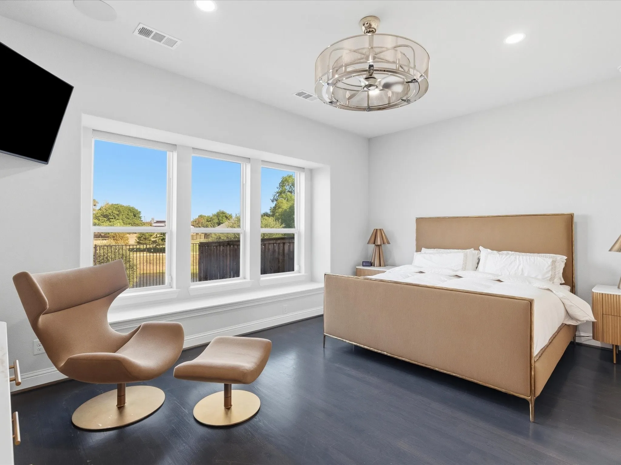 Expansive window with a window seat, dark wood-finish flooring, recessed lighting, and a contemporary ceiling fan with integrated lighting